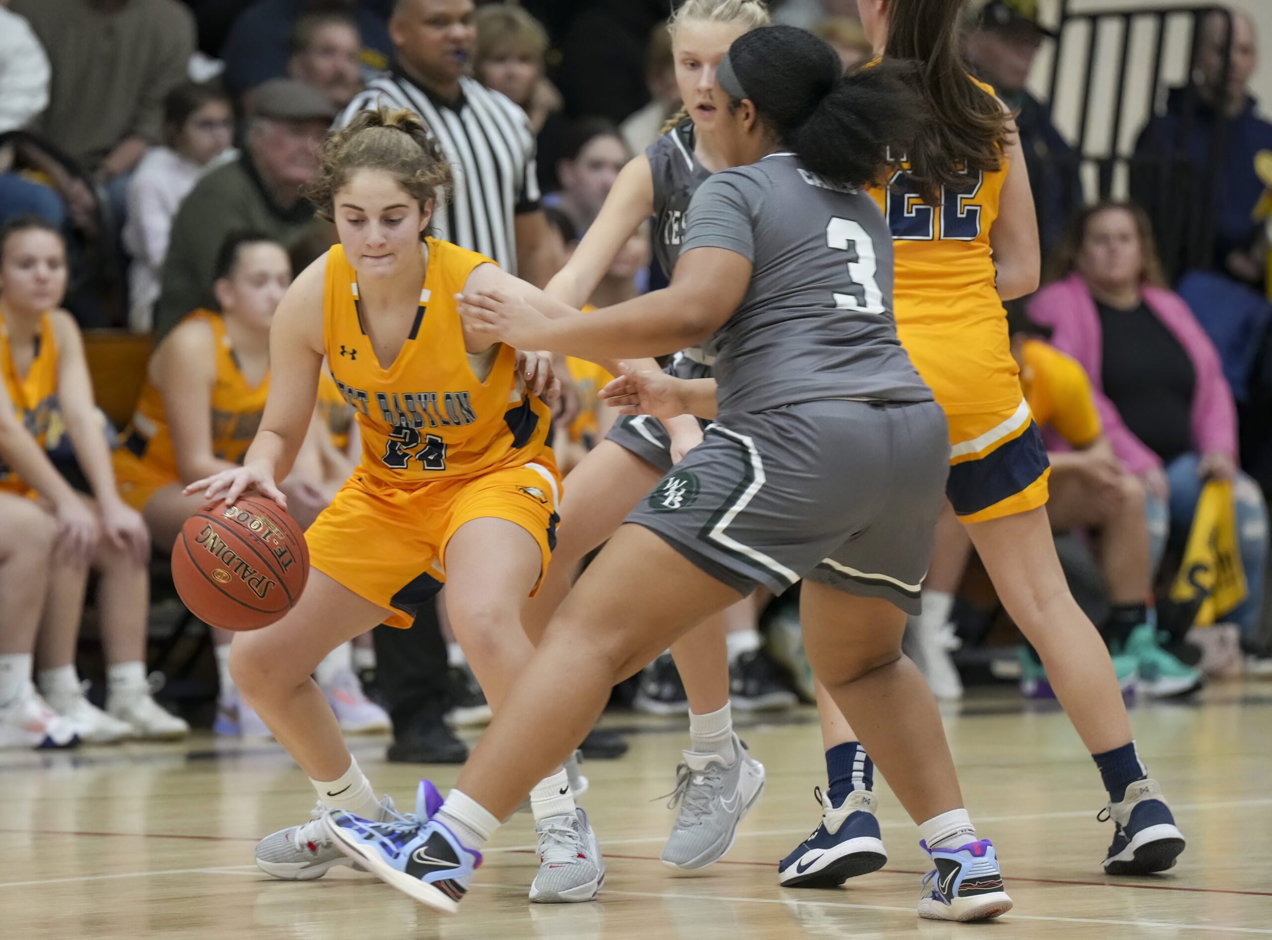 Hurricanes Sandra Clarke and Shannon Sweet try and trap West Babylon senior Rebecca Vitale.   RON ESPOSITO