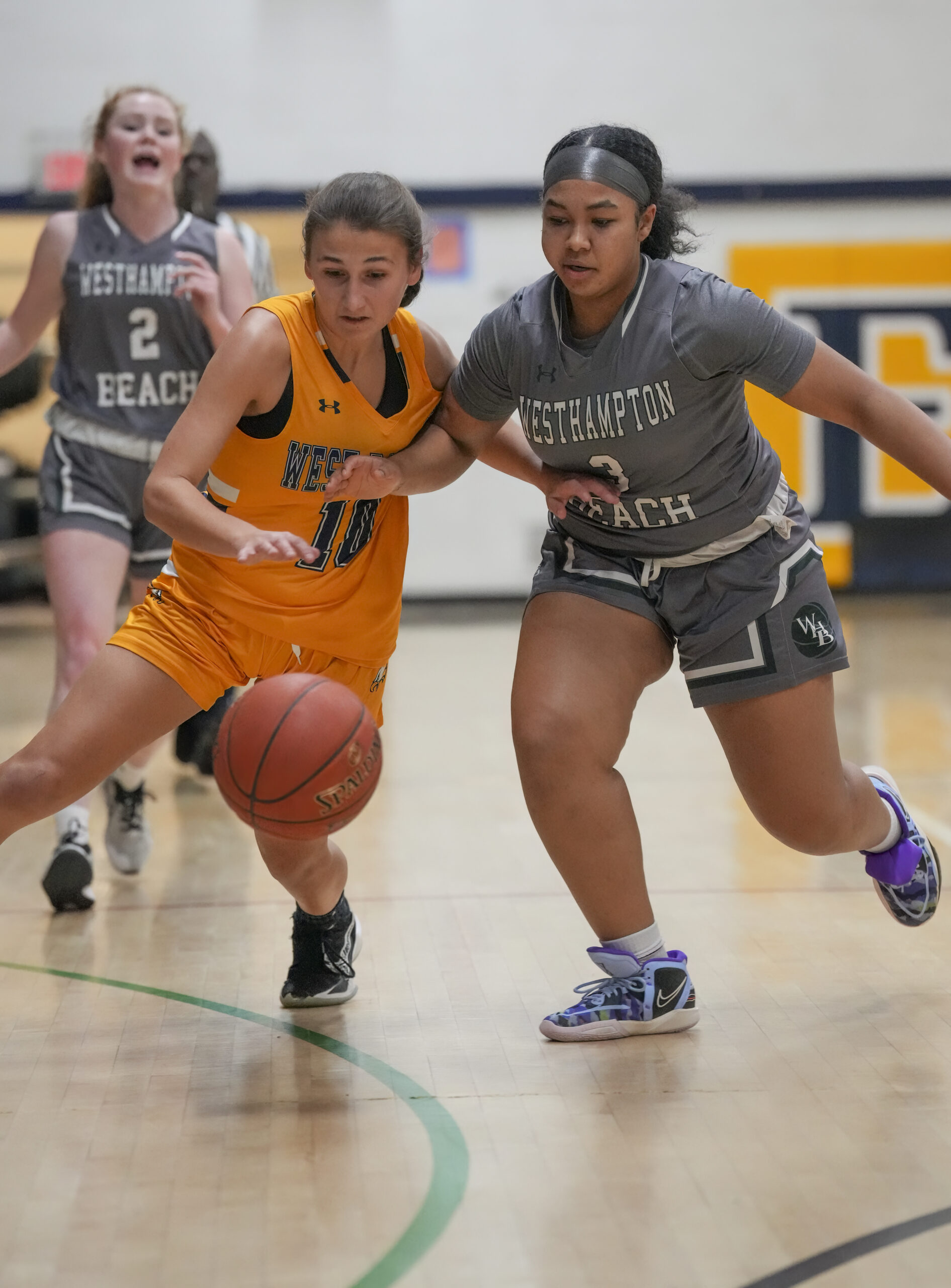 West Babylon senior Lacey Downey and Westhampton Beach freshman Sandra Clarke go after a loose ball.   RON ESPOSITO