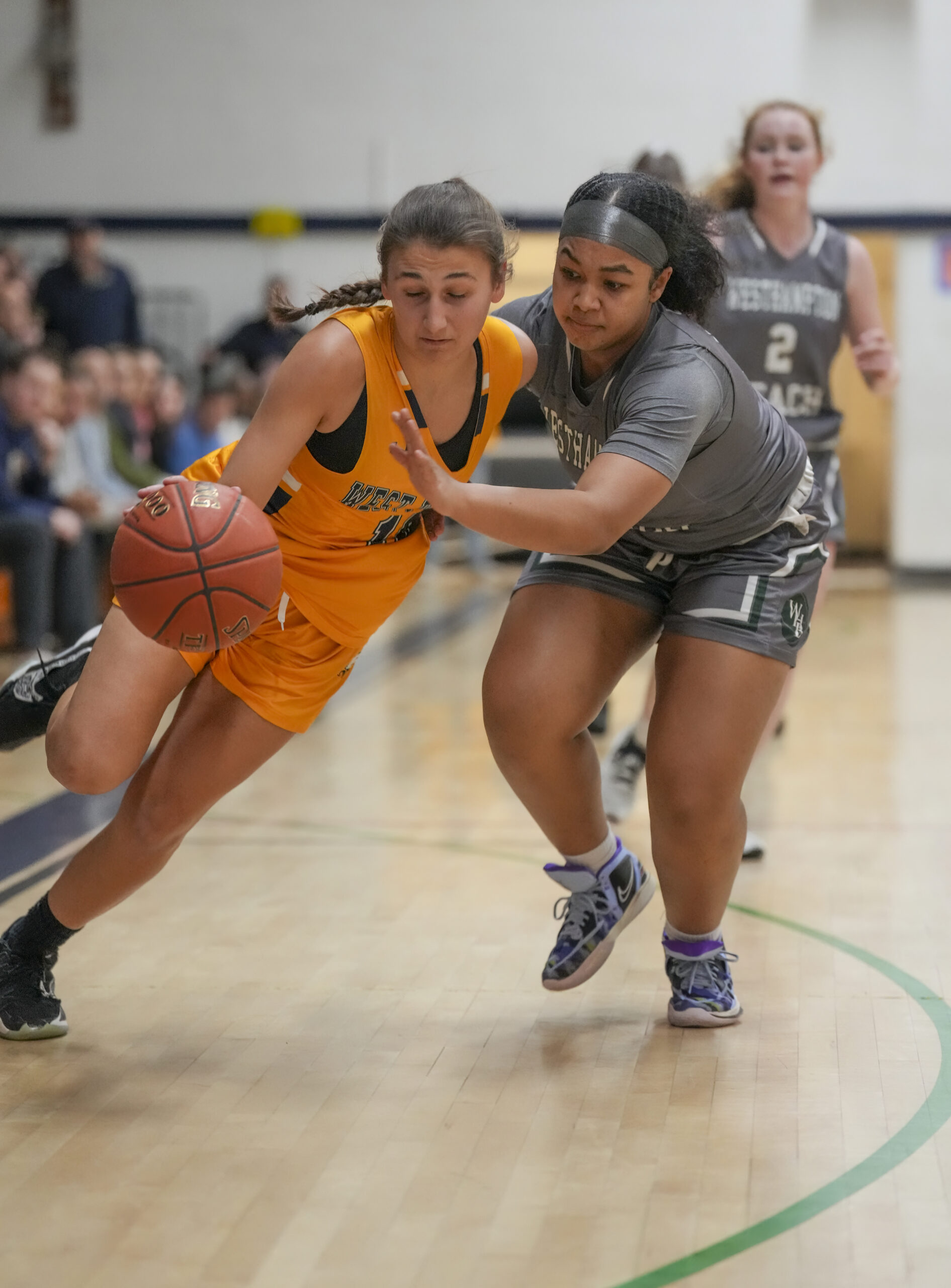 West Babylon senior Lacey Downey and Westhampton Beach freshman Sandra Clarke go after a loose ball.   RON ESPOSITO