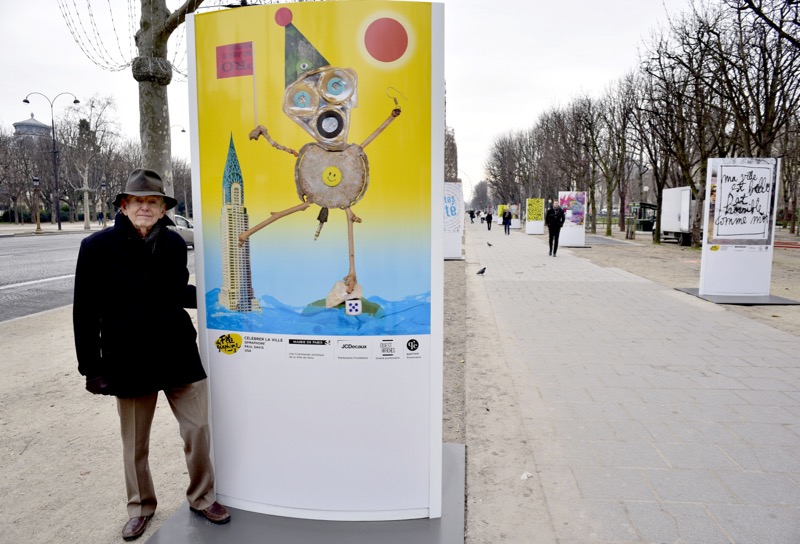 Sag Harbor artist Paul Davis with his “Celebrate the City” poster on the Champs Ulysses, Paris. Didier Pruvot photo. 