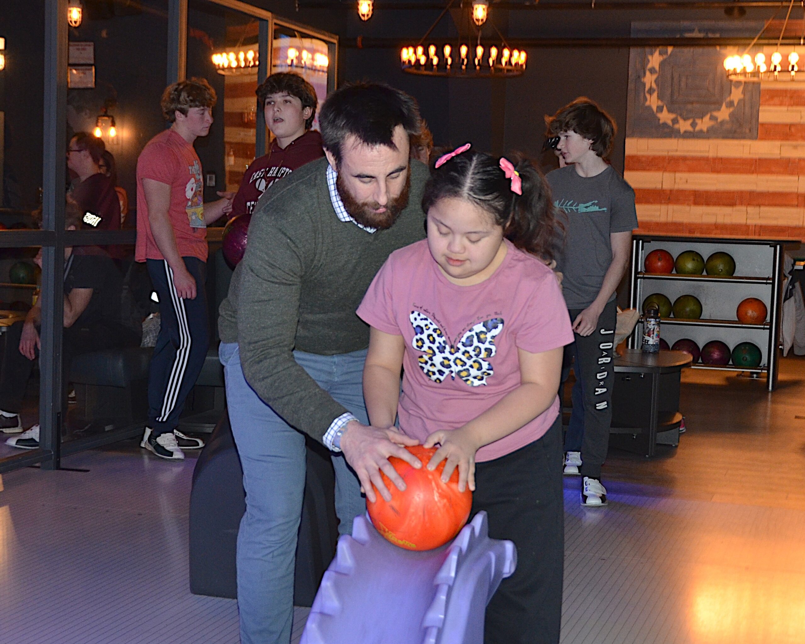 East Hampton head coach Ethan Mitchell helps Nicole Verdugo bowling down the ramp at The Clubhouse in East Hampton on Monday.    KYRIL BROMLEY
