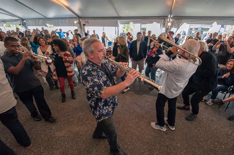 The horn section from the HooDoo Loungers parade through the Big Tent on Sunday afternoon. 