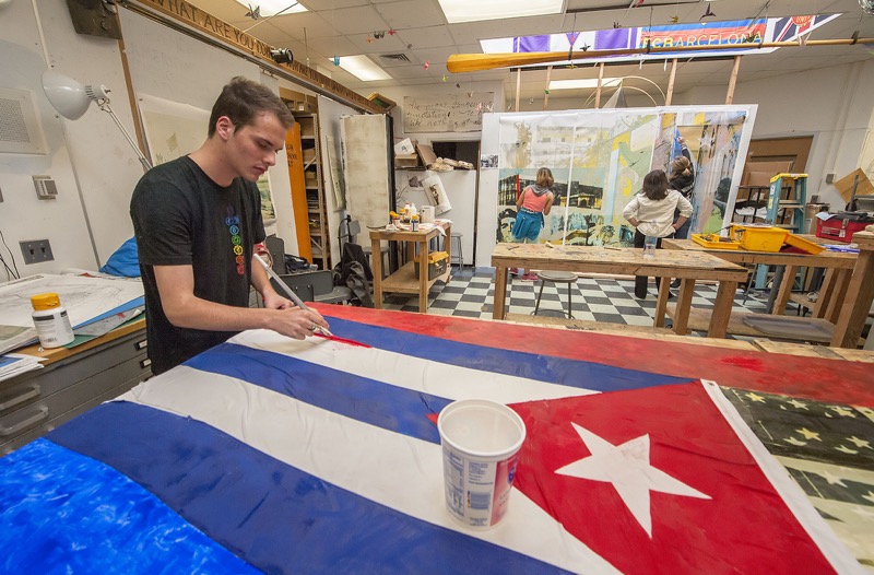 Pierson High School senior Max Micallef works on a mural inspired by his class trip to Cuba. 