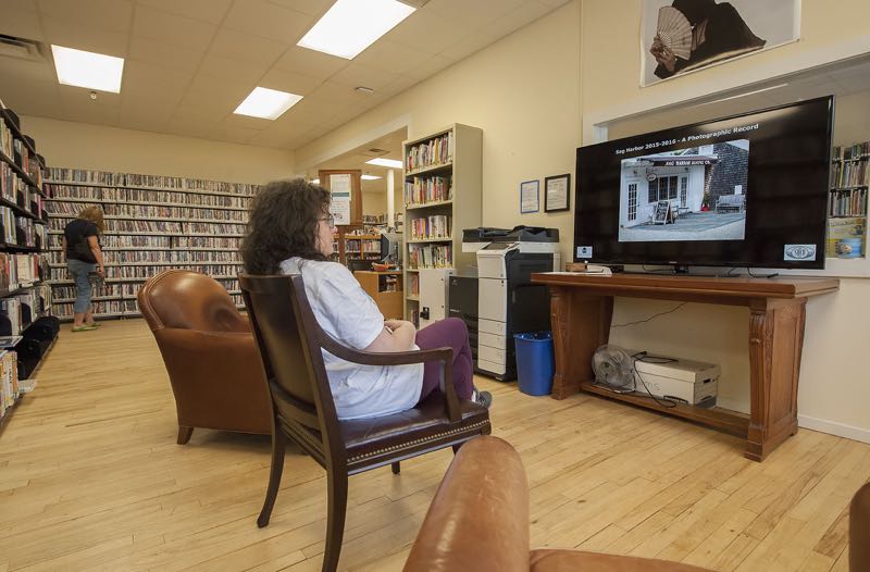 Janet Verneuille checks out images being displayed as part of the 