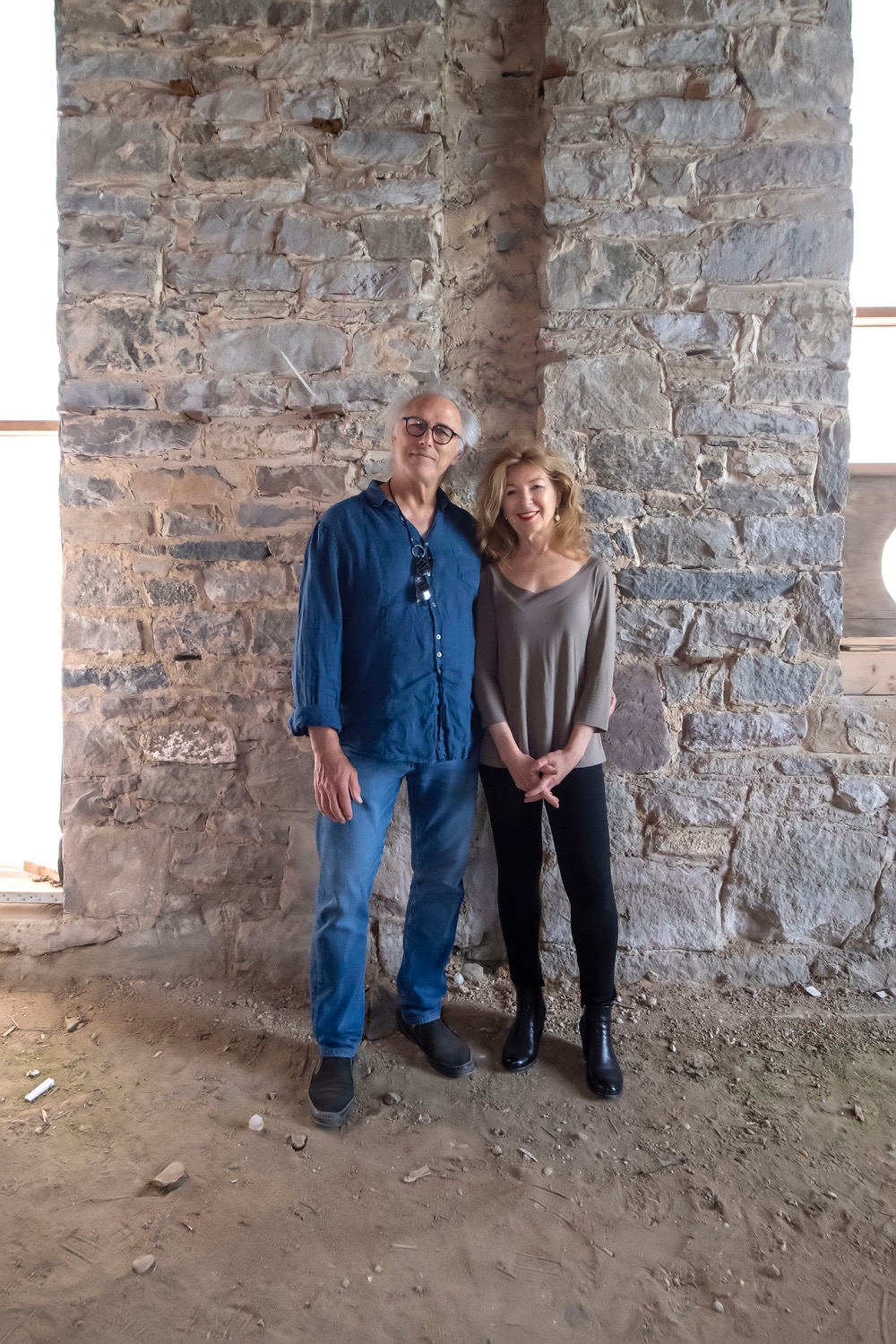 April Gornik and Eric Fischl stand against an original stone foundation wall inside the former Sag Harbor United Methodist Church.