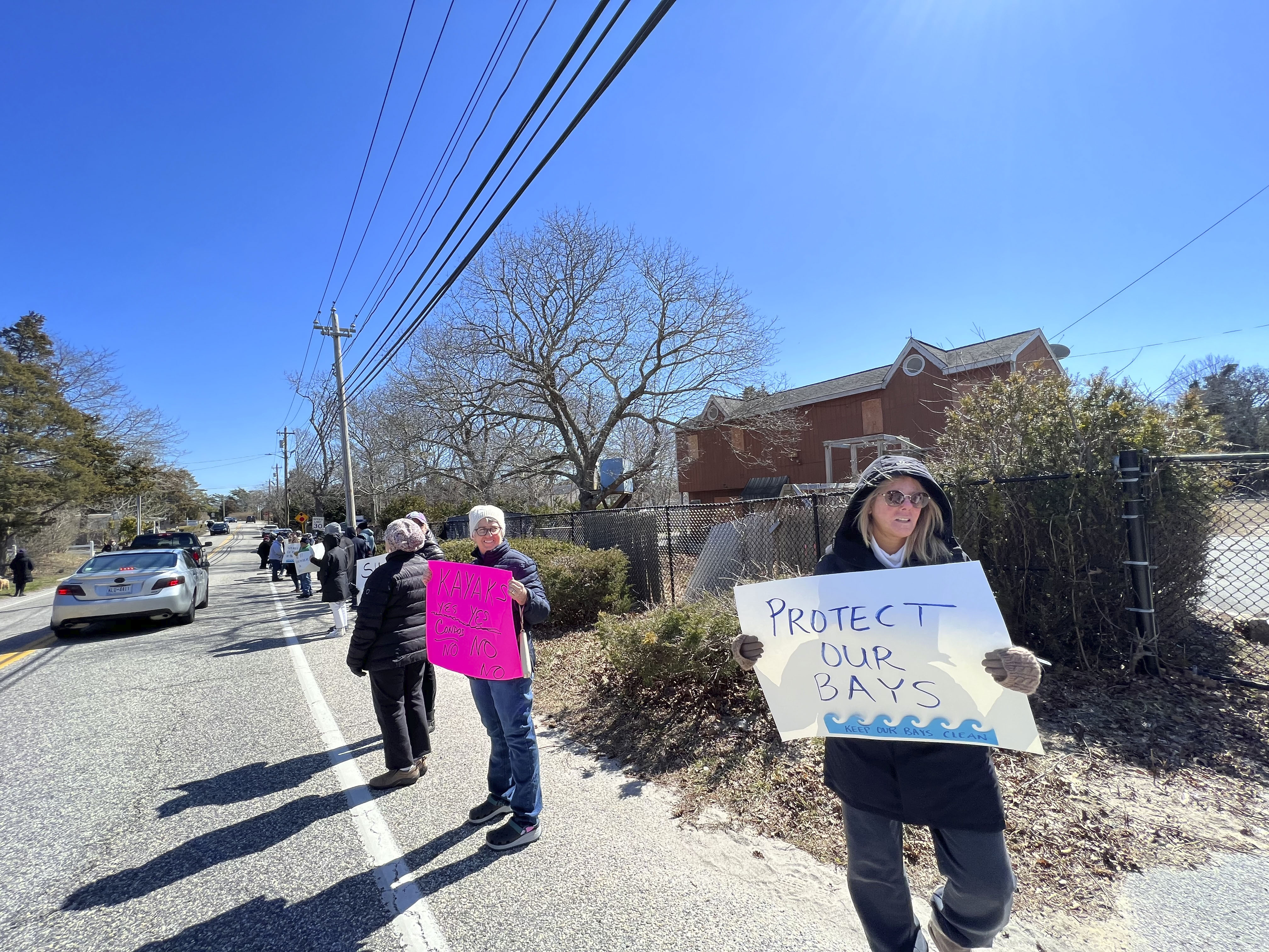 Protesters gather at the former Bel-Aire Cove Motel site on Sunday.  DANA SHAW