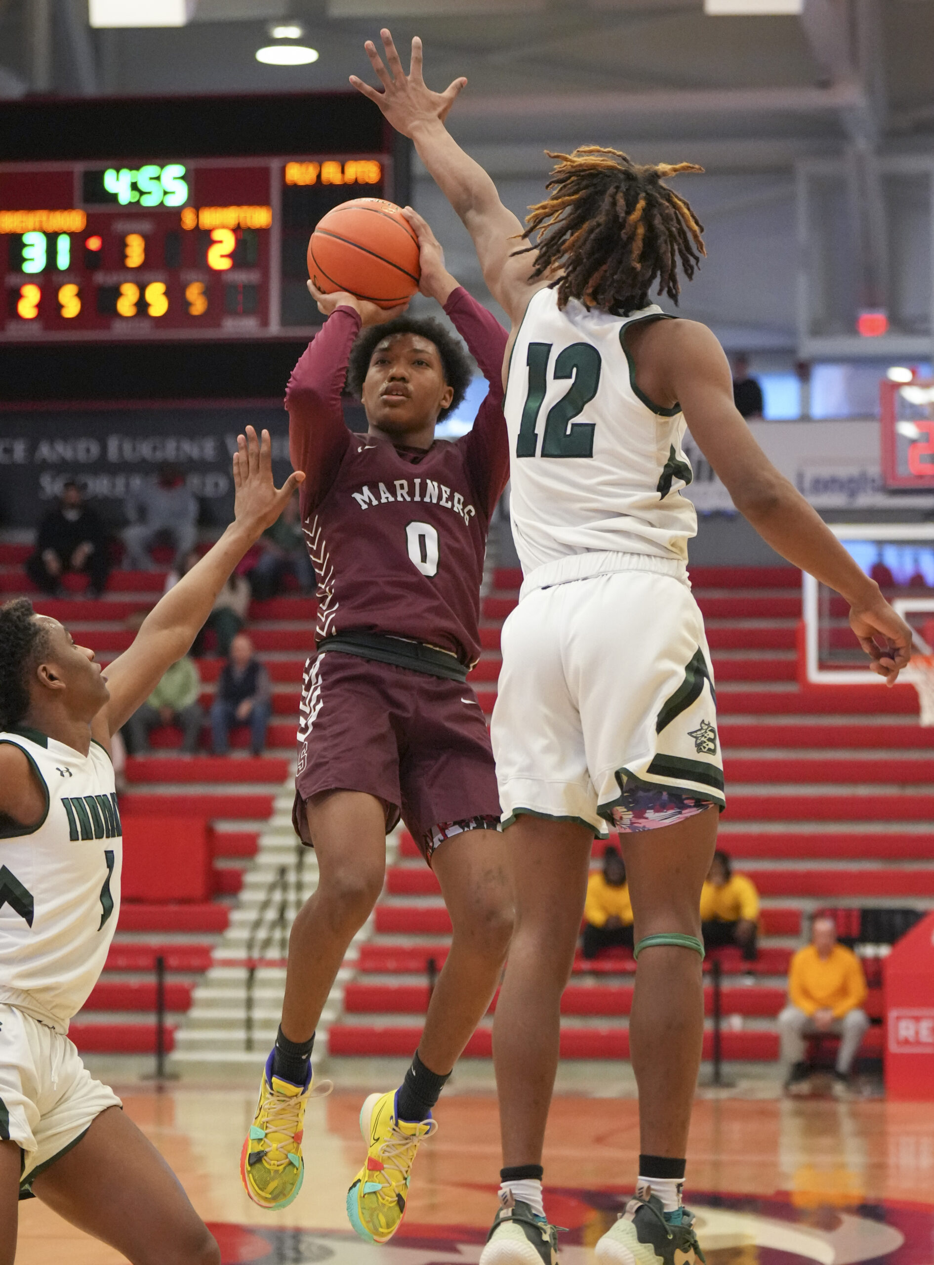 Mariner Naevon Williams tries to shoot over Brentwood junior Marquese Dennis.   RON ESPOSITO