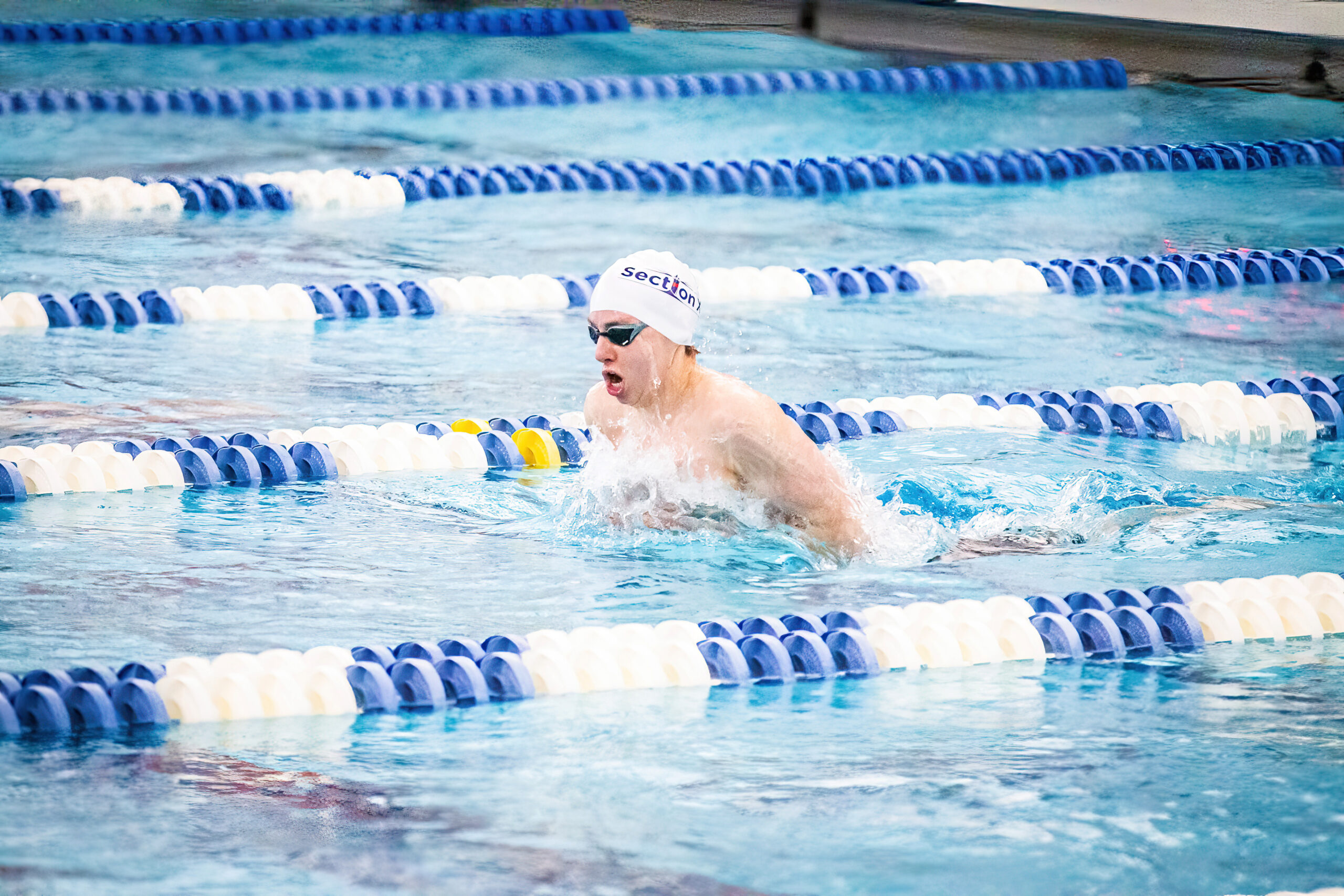 Westhampton Beach junior Max Buchen placed third among public school swimmers and fourth in the federation in the 100-yard breaststroke at the state championships March 3 and 4. DAVID WILLIAMS/BEYOND THE PRINT