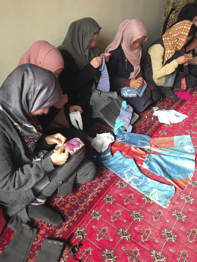 Afghan women gathering to learn tailoring skills to support themselves and each other before the return of the Taliban.