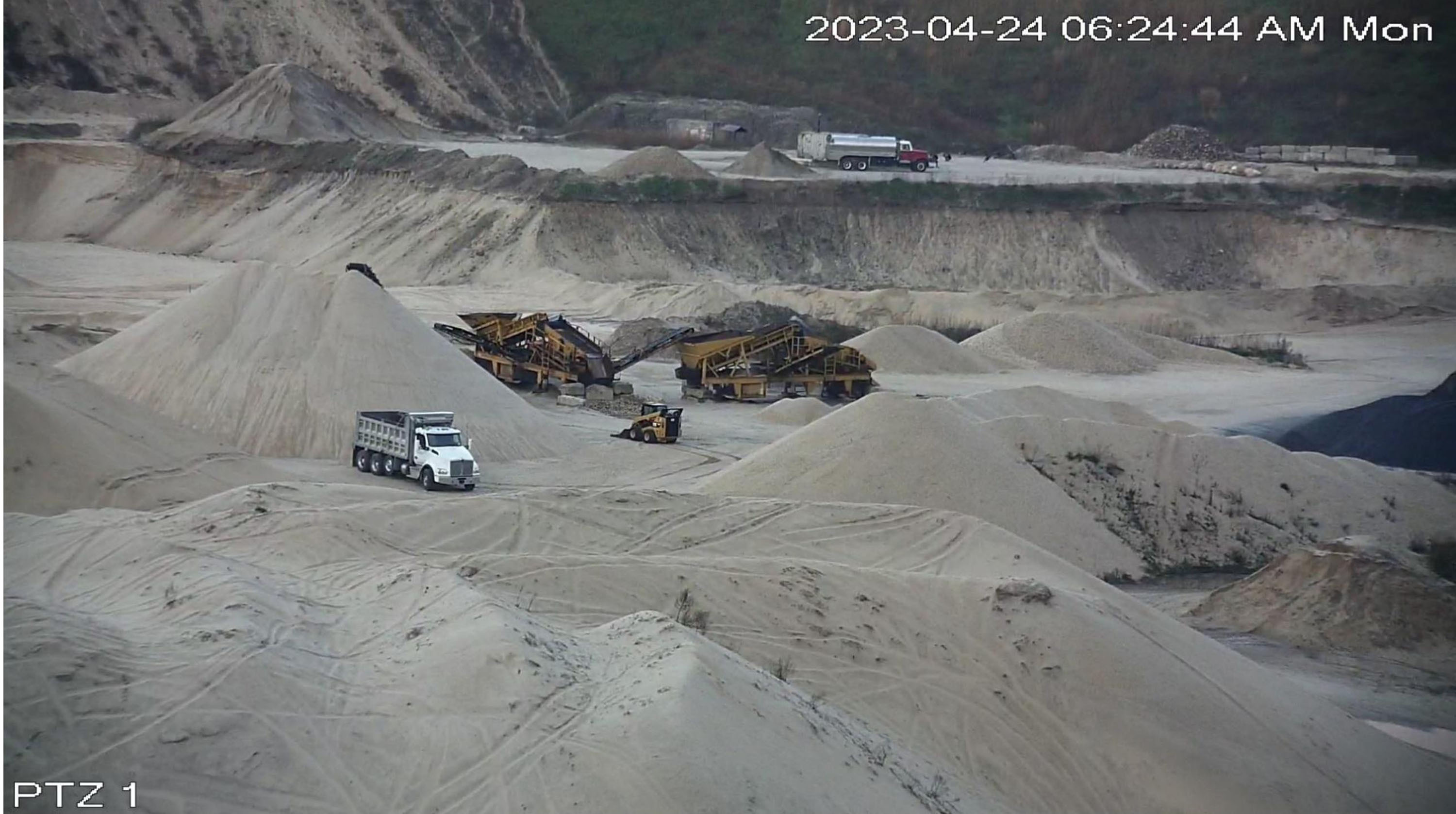 A photograph from a neighboring property shows activity at the Sand Land mine in Noyac.