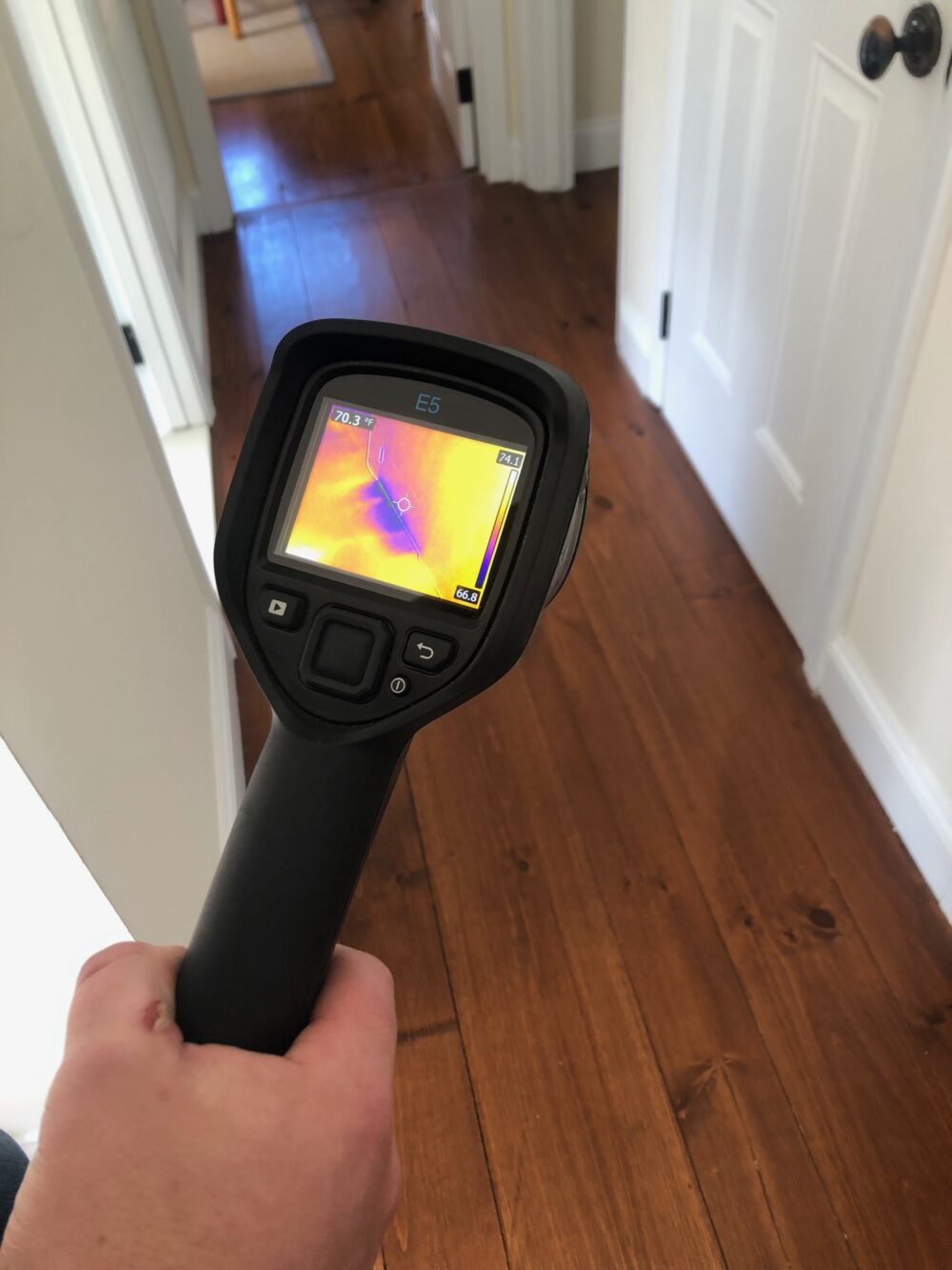 GreenTeam LI auditor using infrared technology to see where cold air comes up from my basement. Free energy audits help with how to make your house much more energy efficient. JENNY NOBLE