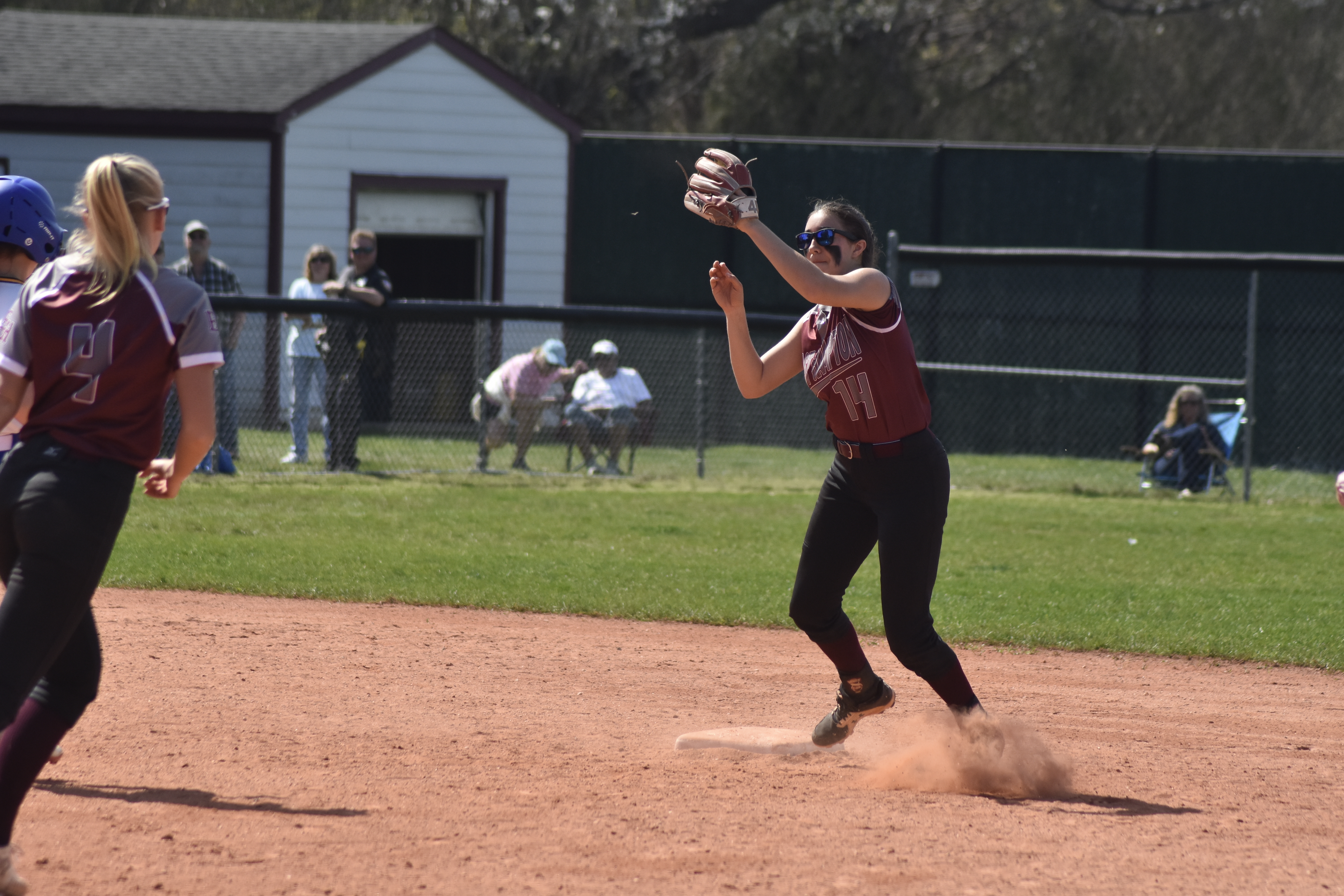 East Hampton senior shortstop Emma Terry catches a throw from senior second baseman Alyssa Brabant for an out.   DREW BUDD