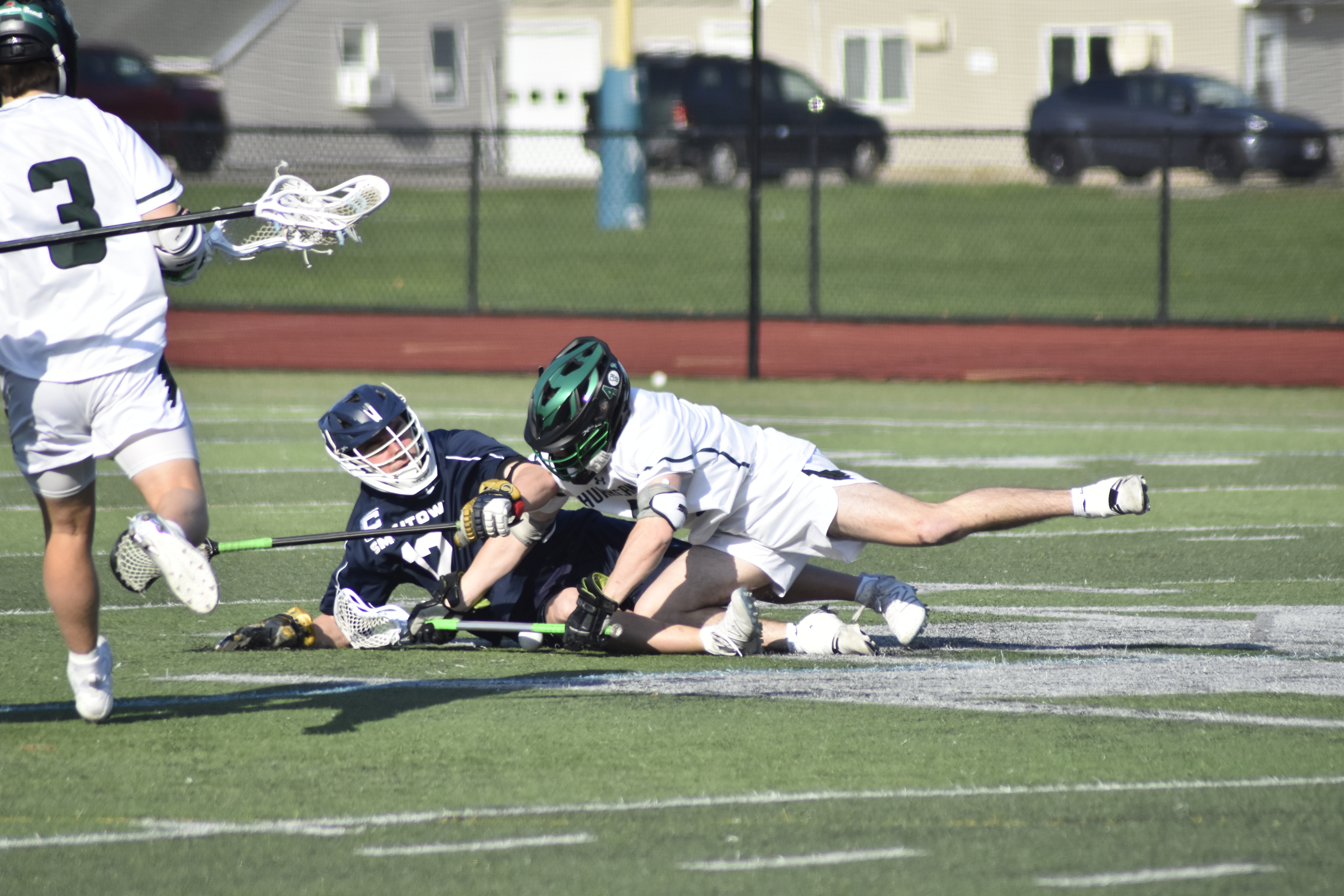 Westhampton Beach junior Nolan MIchalowski battles with a Smithtown West player for ball control off a faceoff.   DREW BUDD