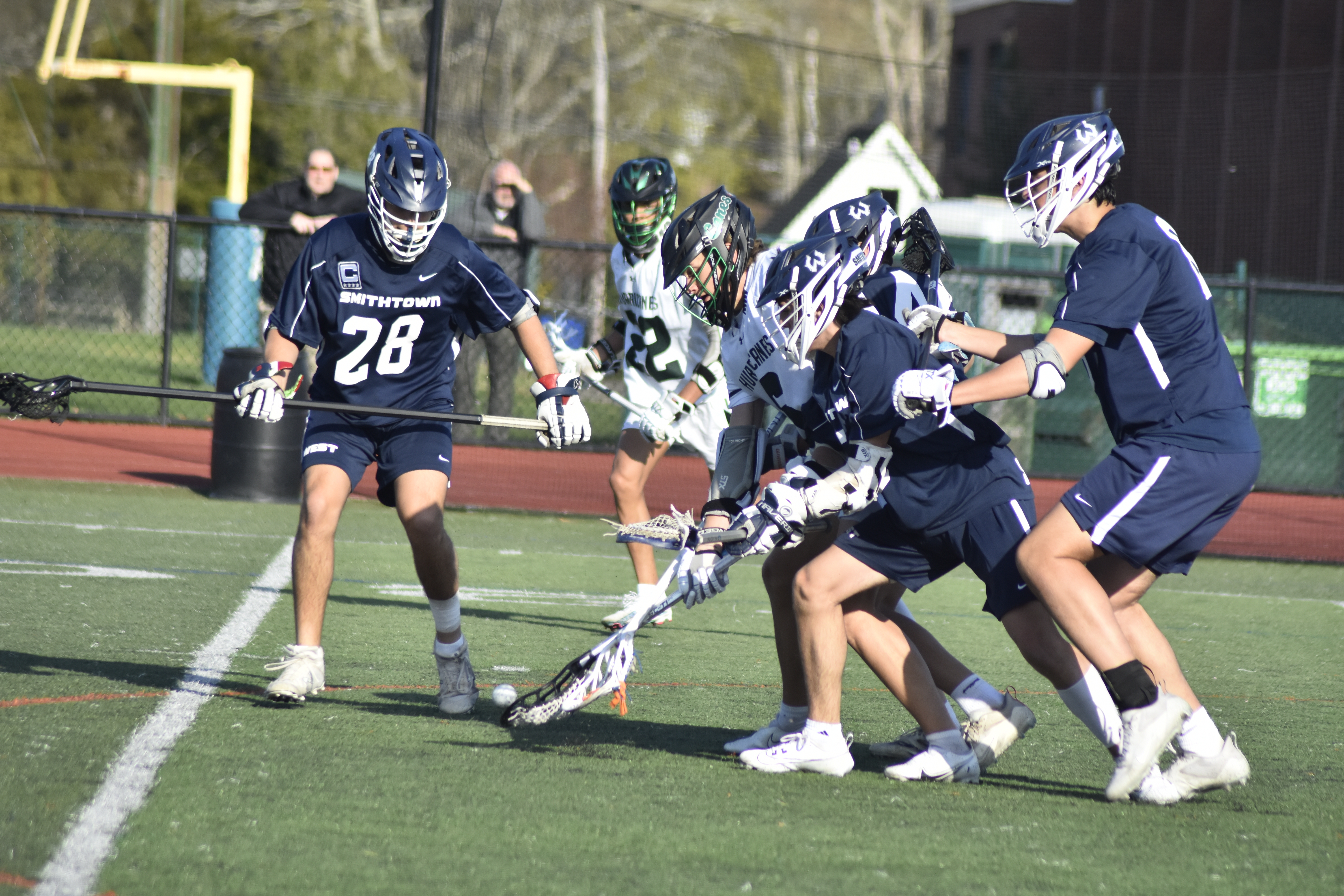 Westhampton Beach junior Dante Mansfield fights through three Smithtown West players to try and grab a loose ball.   DREW BUDD