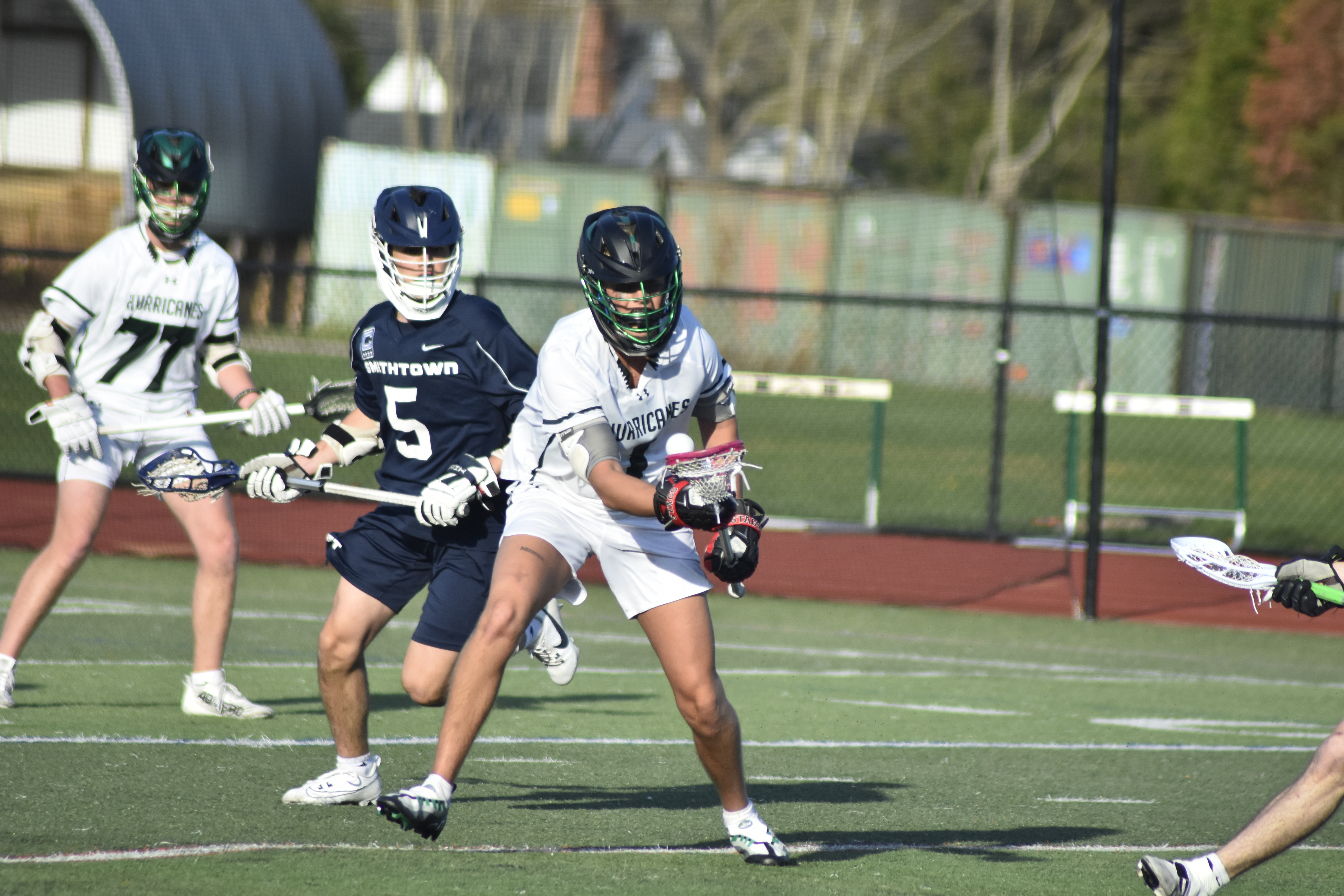 Westhampton Beach senior Aidan McAuley picks up a ground ball at midfield.   DREW BUDD