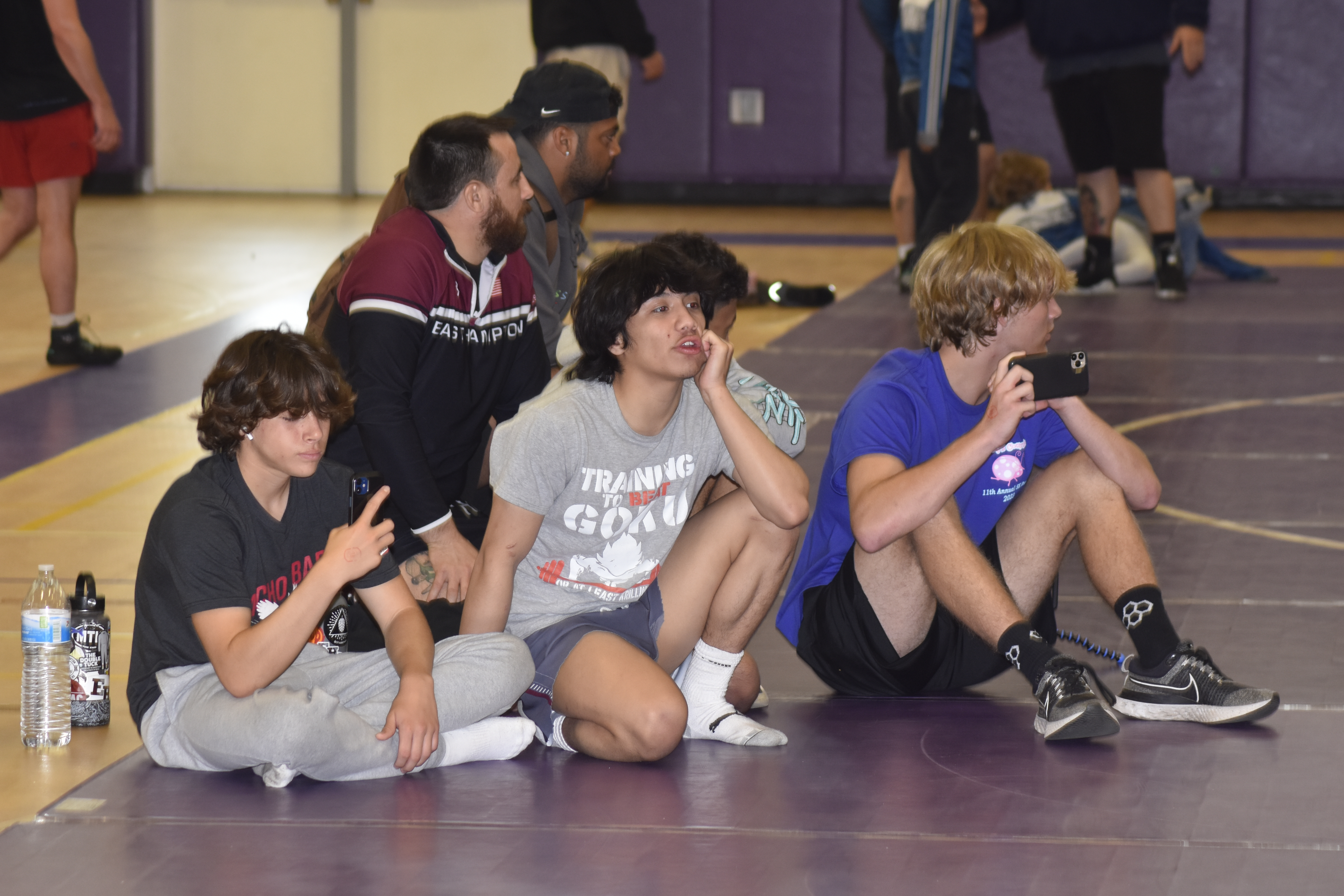 Current Bonac wrestlers cheer on their assistant coach   who is competing in a match.   DREW BUDD