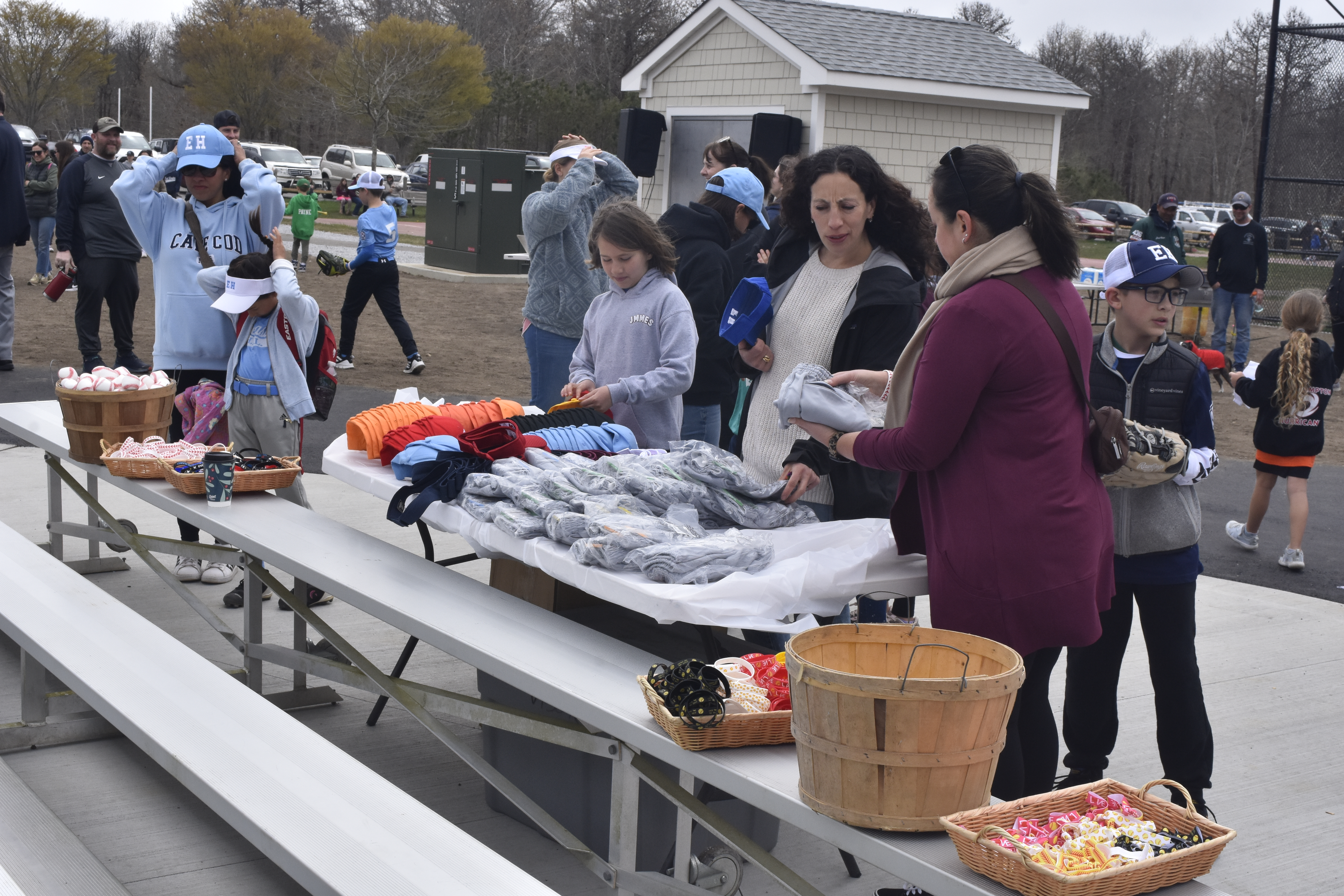 Players and parents pick up their hats and uniforms in addition to some other swag.   DREW BUDD