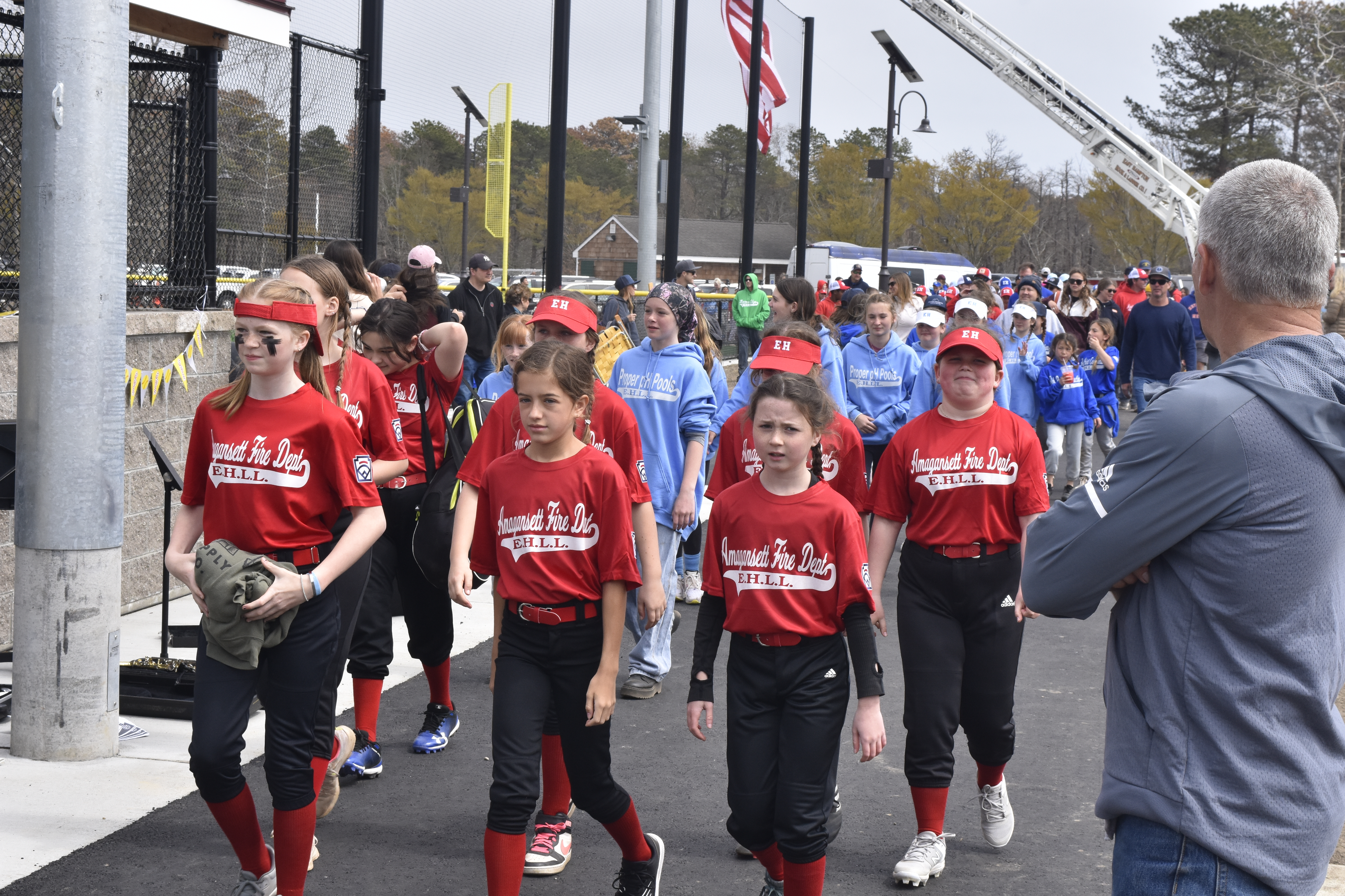 East Hampton Little League Vice President Dave Rutkowski directs players and coaches on to the field.   DREW BUDD