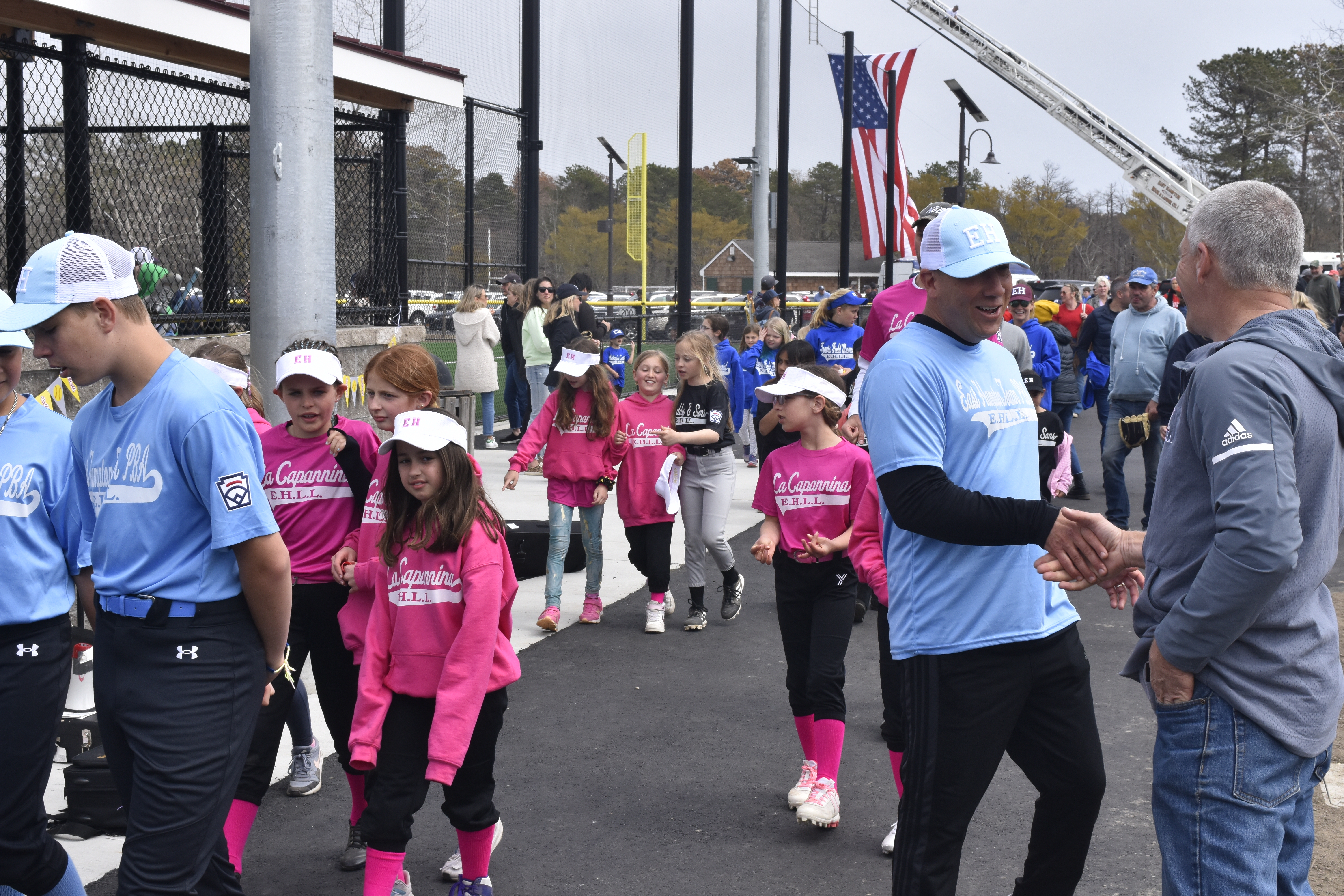 East Hampton Little League Vice President Dave Rutkowski directs players and coaches on to the field.   DREW BUDD