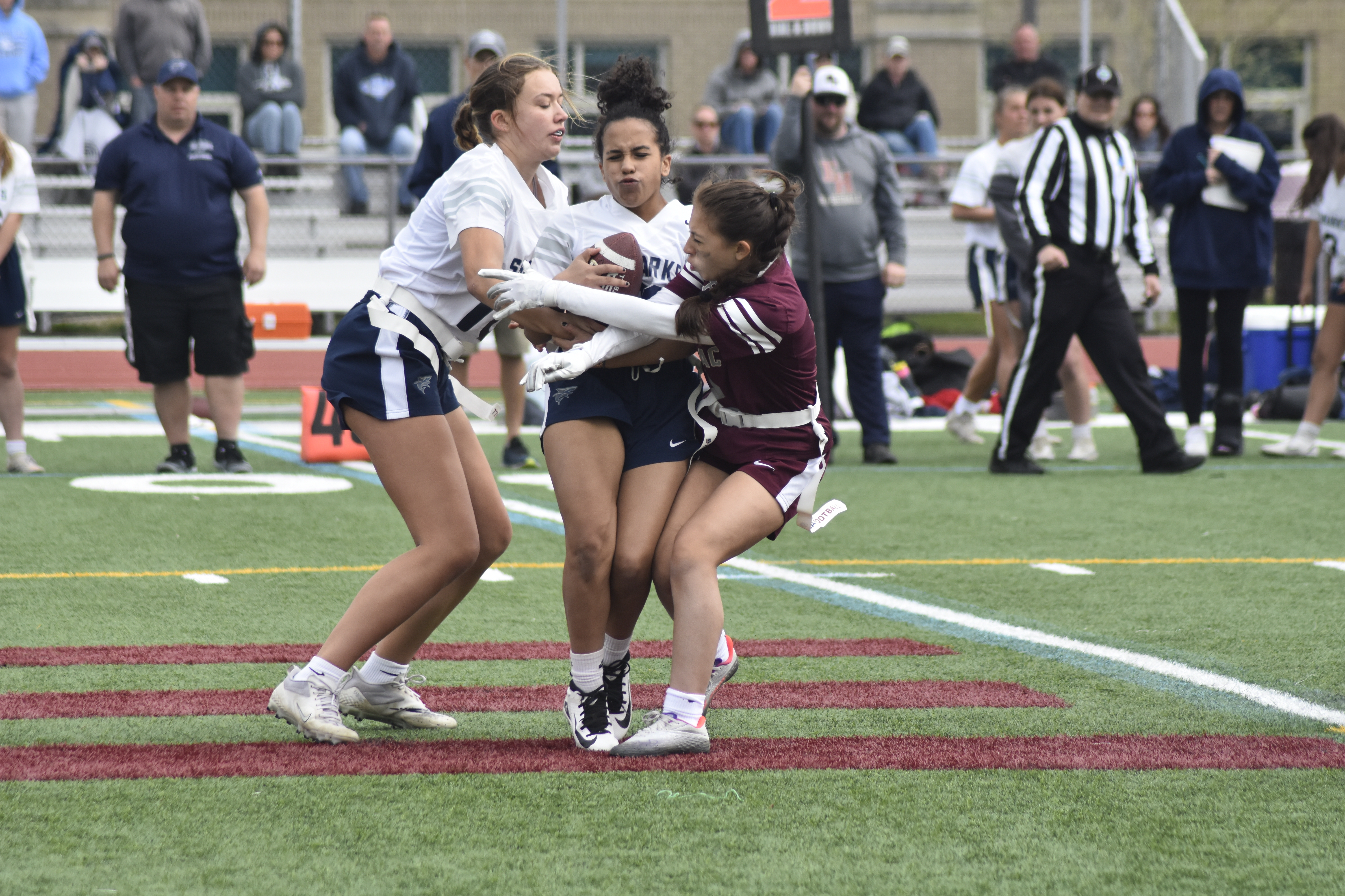 East Hampton's Salome Galindo disrupts a player in the ESM backfield.   DREW BUDD