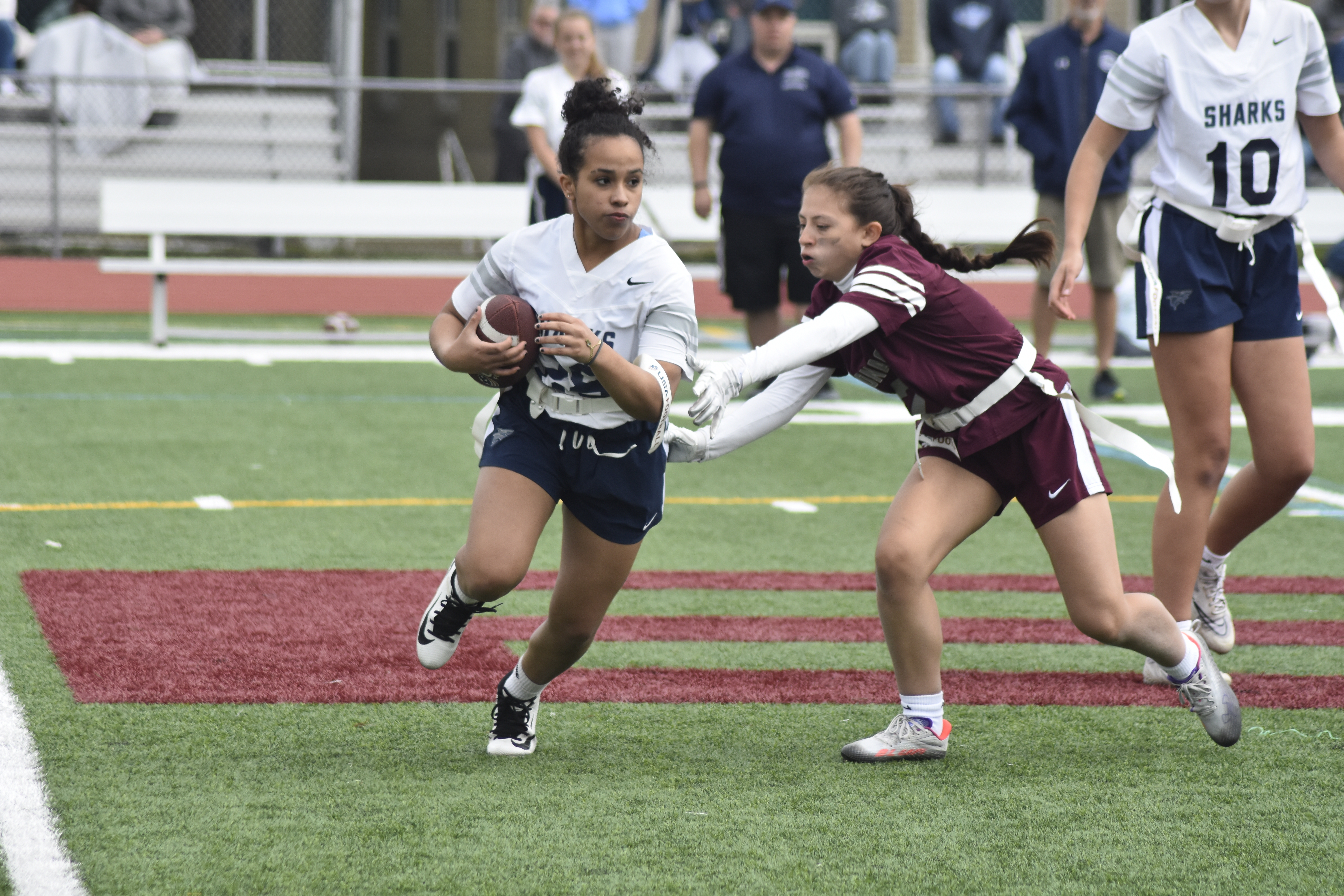 East Hampton's Salome Galindo gets the flag of an ESM player.   DREW BUDD