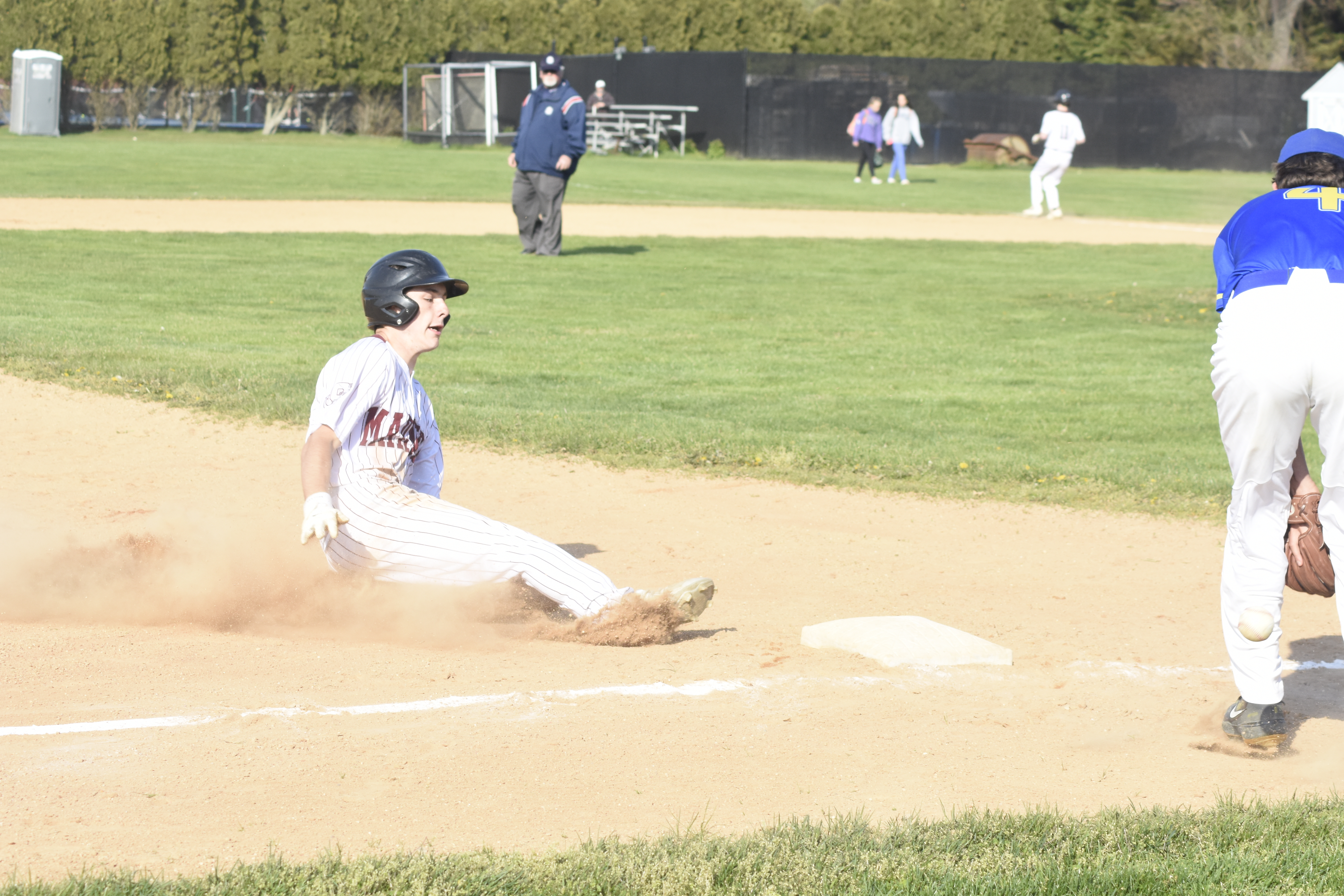 Southampton senior Douglas Dunkirk slides safely into third base. He would later score the Mariners first run of the game.   DREW BUDD