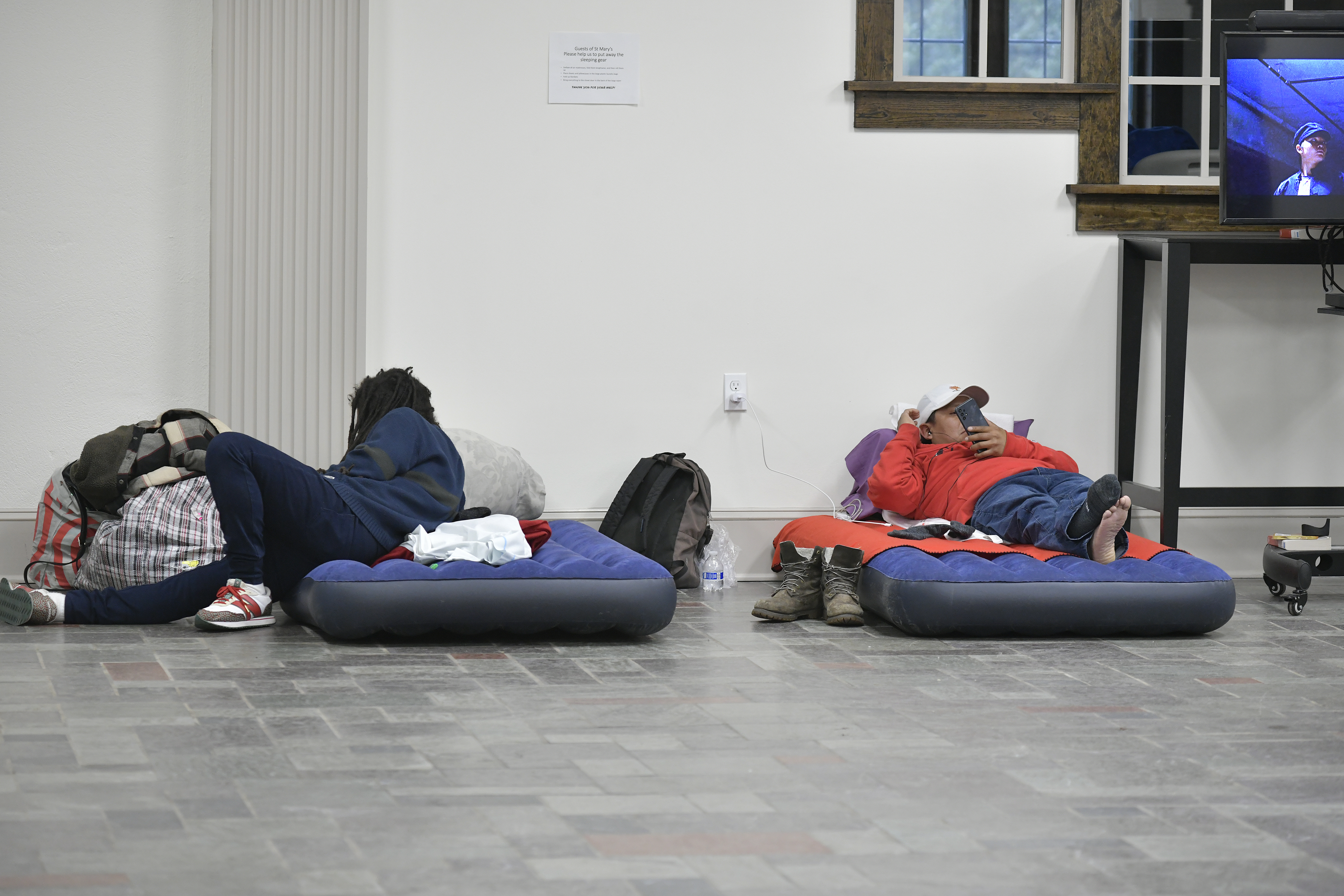 Guests on the last night of the winter emergency overnight shelter services provided by Maureen’s Haven at St. Mary's Episcopal Church in Hampton Bays.     DANA SHAW