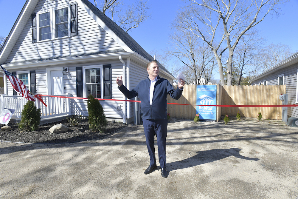 Jimmy Jack, CEO for Habitat for Humanity of Long Island welcomes the crowd to the ribbon cutting.  DANA SHAW