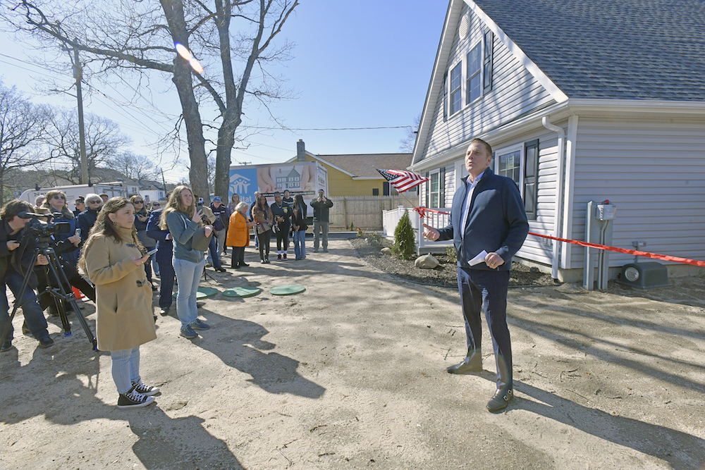 Jimmy Jack, CEO for Habitat for Humanity Long Island welcomes the crowd to the ribbon cutting.  DANA SHAW