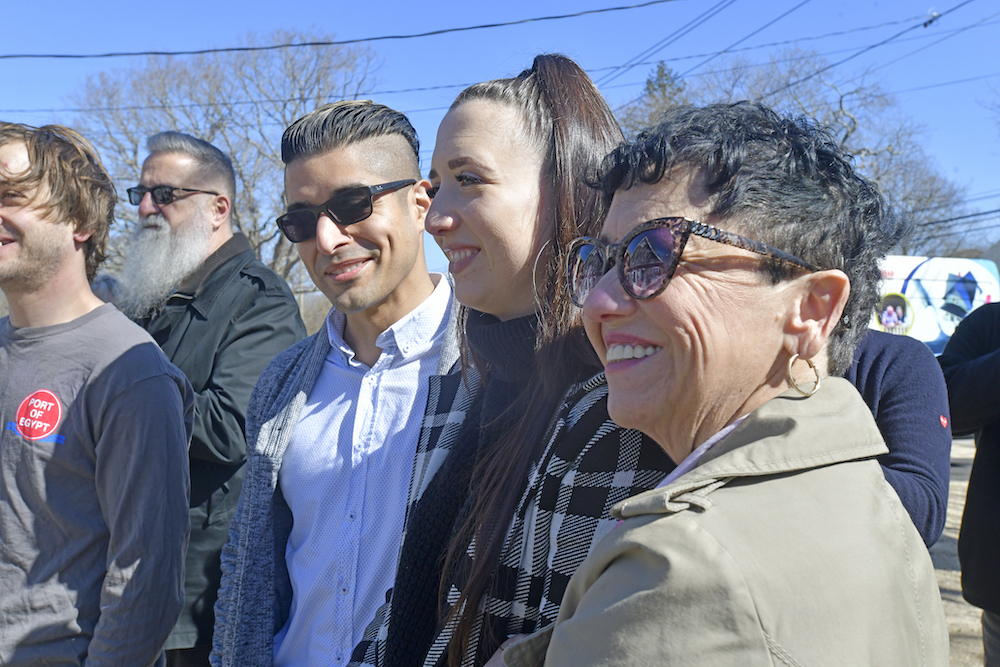 Chris and Amanda Hoyos, center with their family at the ribbon cutting of their home on Monday morning.  DANA SHAW