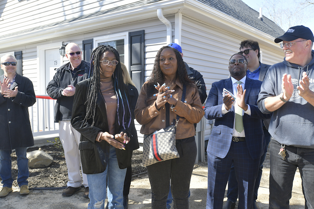 Homeowner Sahlise Cherry, right, with her daughter Jamiya Hopson on Monday at the ribbon cutting.  DANA SHAW