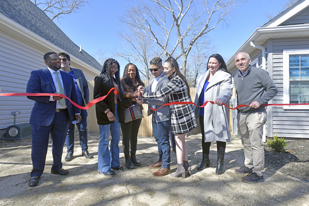 Jamiya Hopson and Sahlise Cherry and Chris and Amanda Hoyos cut the ribbon on their respective house on Monday in Riverside.   DANA SHAW