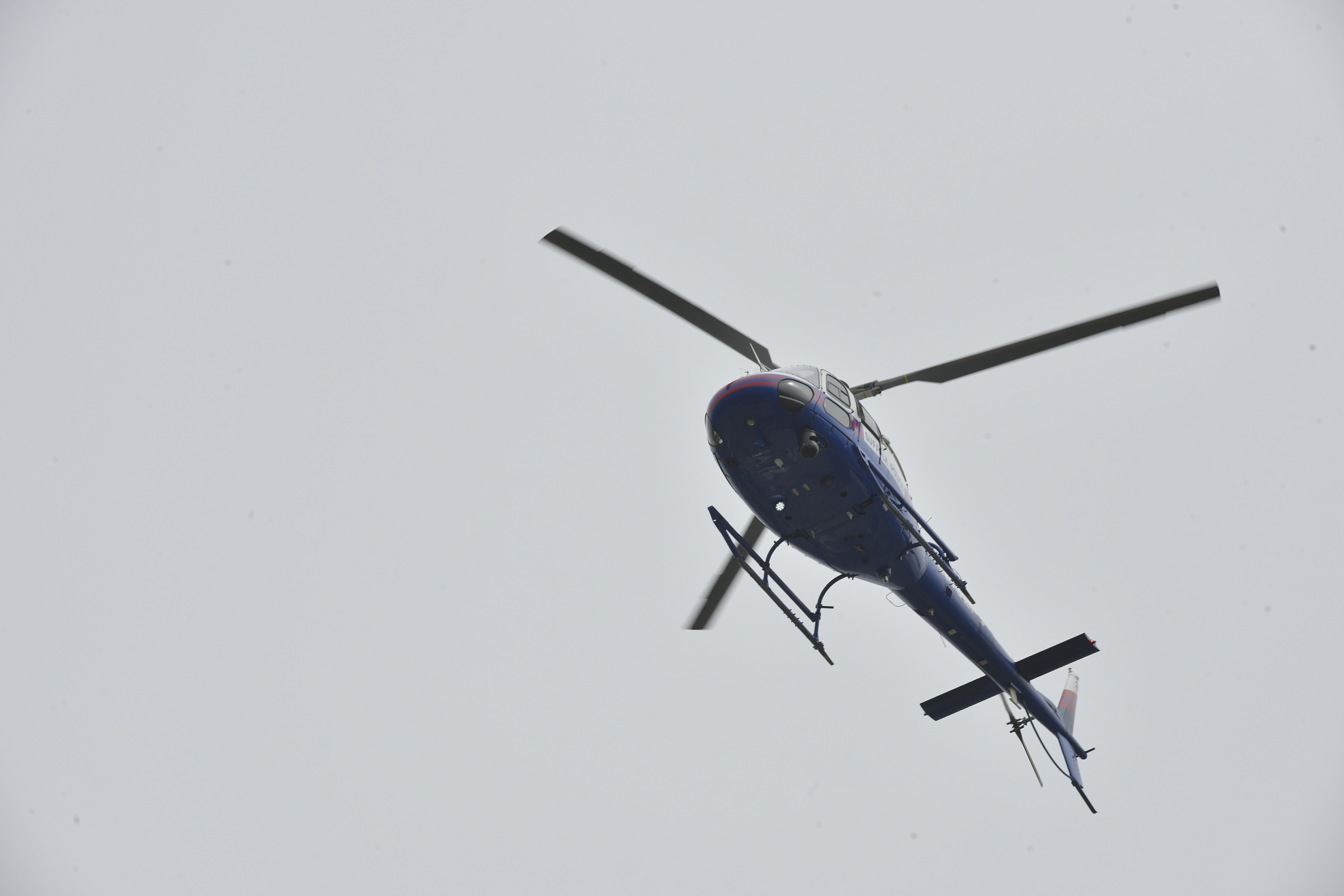 A Suffolk County Police helicopter fly's over the field.