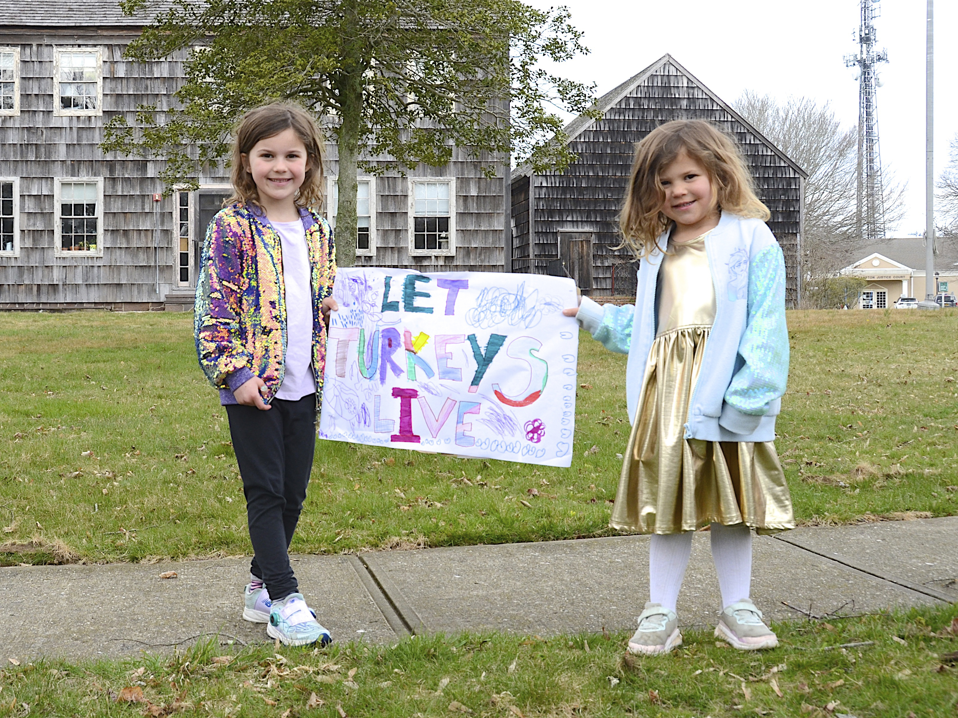 Lyla and Raegan Brabant at the demonstration hosted by the East Hampton Group for Wildlife opposing the addition of a turkey hunting season in May was held in front of Town Hall prior to the meeting on April 6.  KYRIL BROMLEY