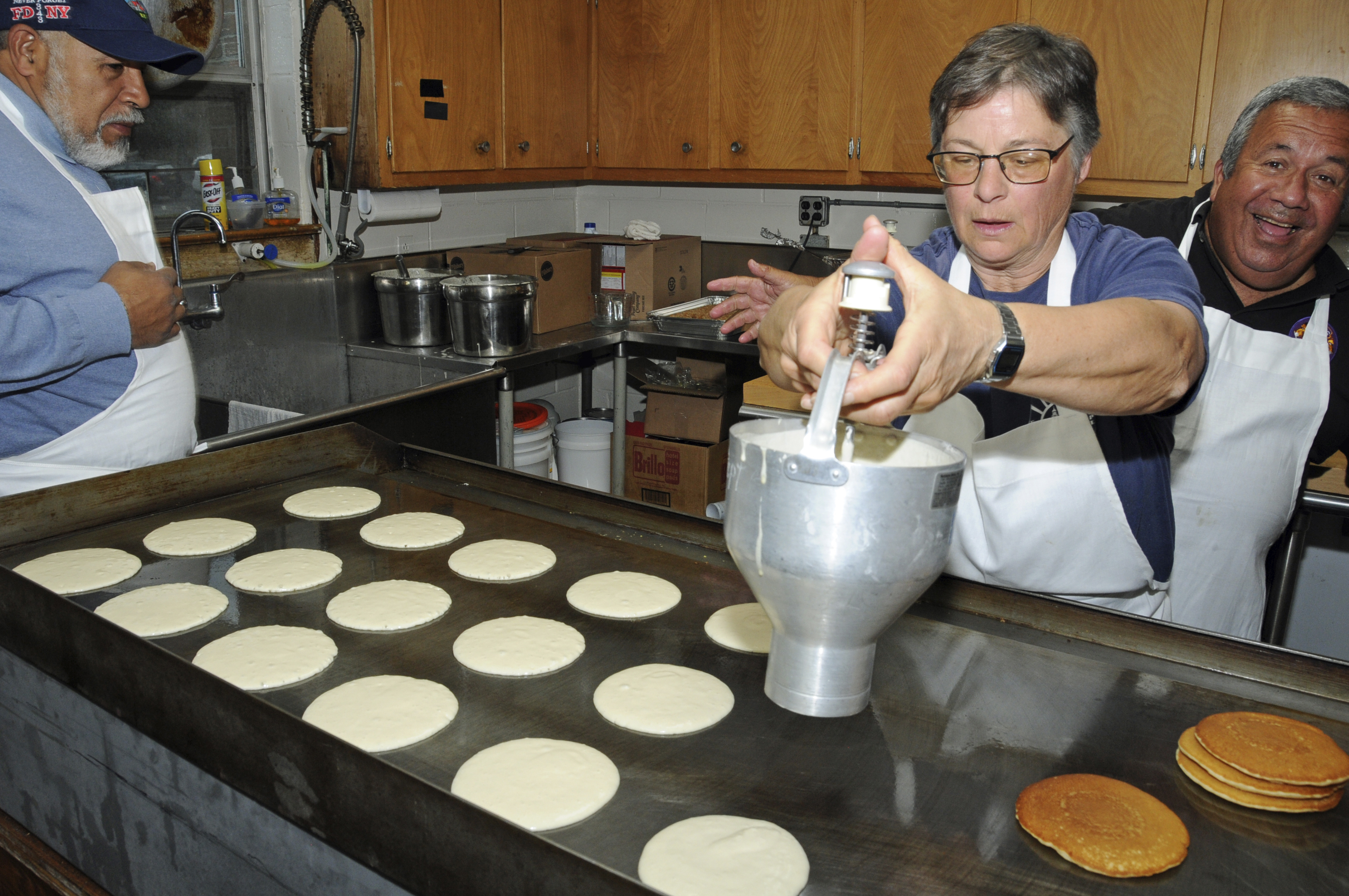 Roberto Taveras, Jeanine Miedzwiecki and Carmine Marino in the kitchen at the Montauk Point Lions Club and the Montauk Fire Department's combined pancake breakfast on Sunday at the firehouse.    RICHARD LEWIN