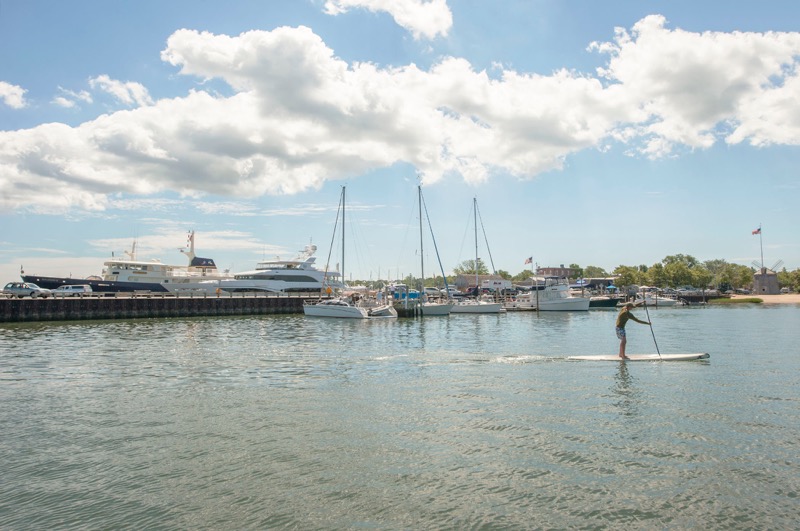 A lone paddle boarder cruises through the harbor off Long Wharf in Sag Harbor. 