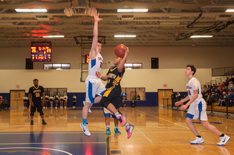 Bridgehamptons's Nae'Jon Ward shoots through a defender as the Killer Bees took on the S.S. Seward Spartans in a state regional semifinal at Mount St. Mary College in Newburgh on Monday. Michael Heller photos