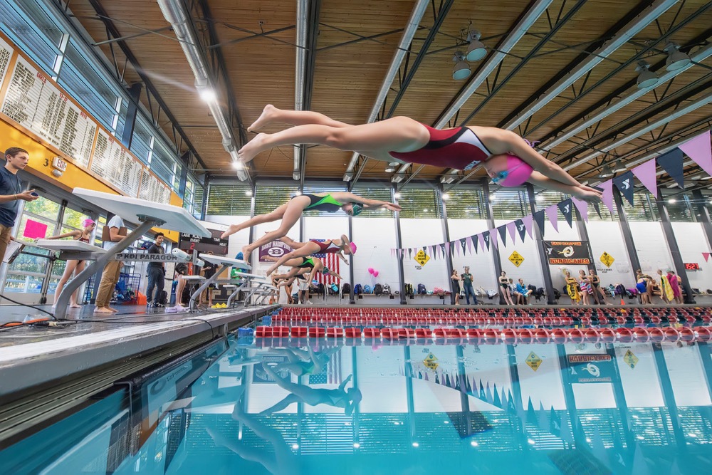 The East Hampton girls swim team beginning a race against Harborfields on October 18 at the YMCA in East Hampton. Michael Heller photos