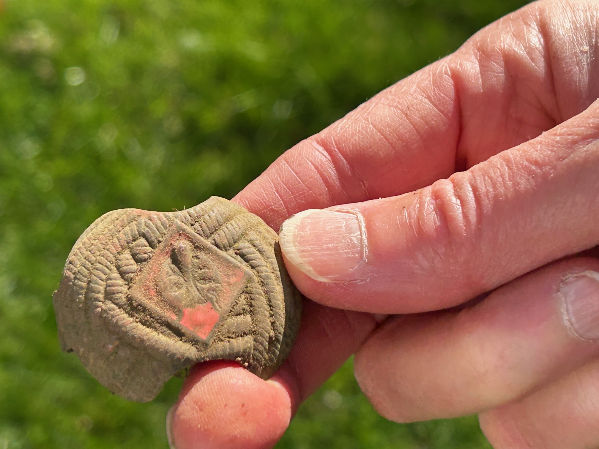 A Cub Scout 'wolf rank' neckerchief slide was unearthed during the search for artifacts at Remsenburg Academy.   KITTY MERRILL