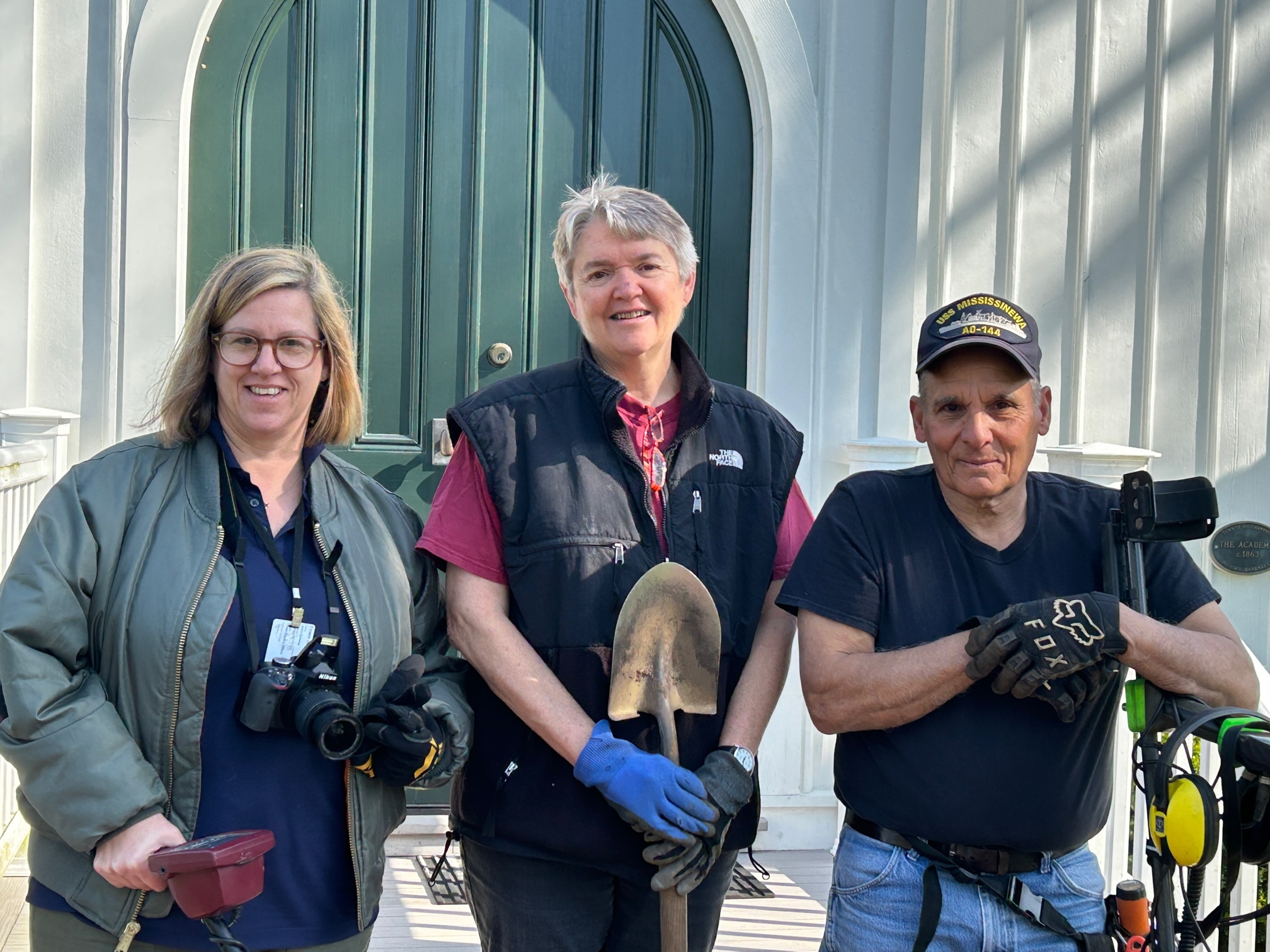 Town Historian Julie Green, Stephanie Davis of the town's Landmarks and Historic Districts Board, and volunteer Larry Andria at the Metal Detecting Project at Remsenburg Academy.   KITTY MERRILL