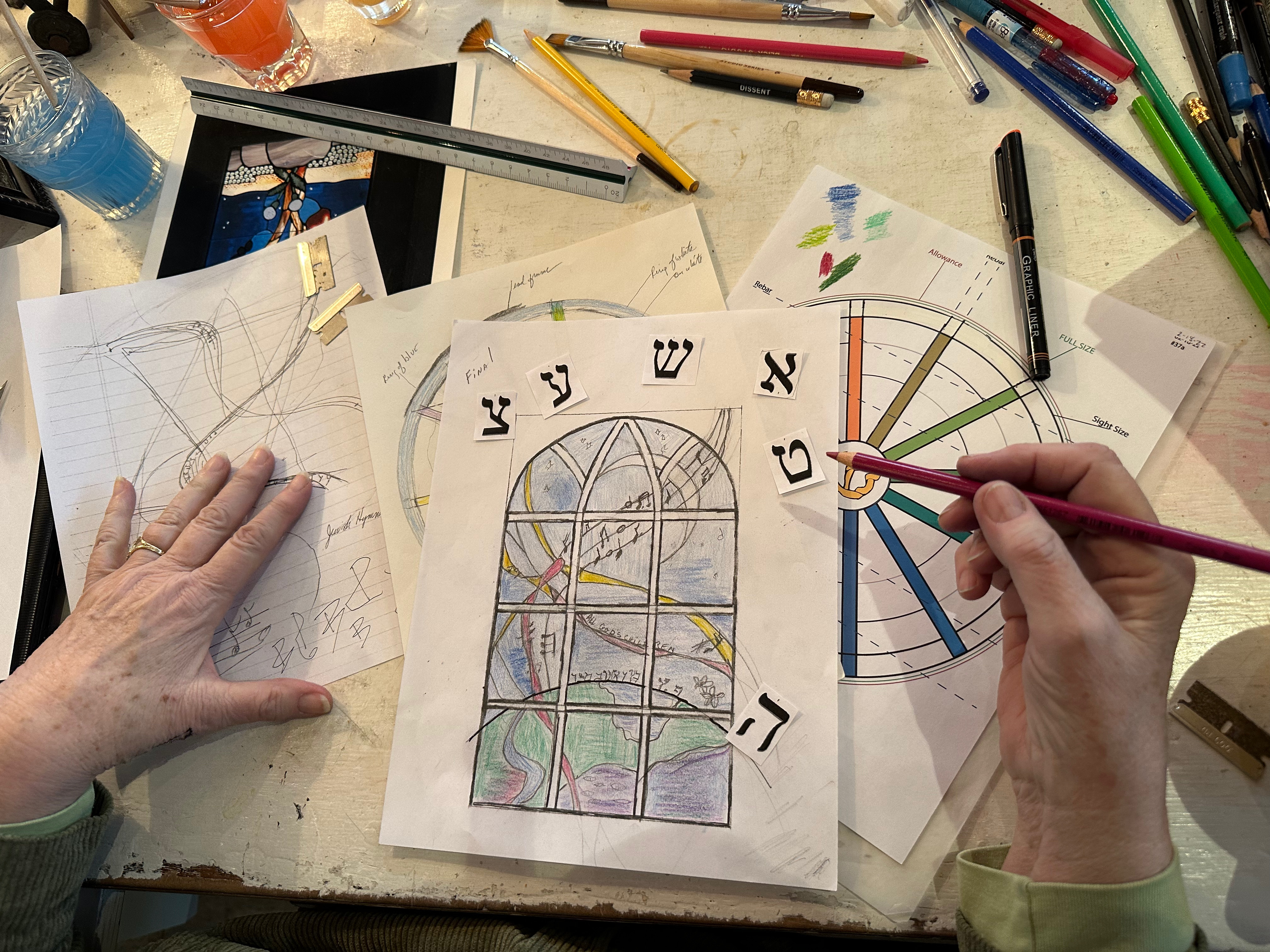 Romany Kramoris at work on a new stained glass window design for Temple Adas Israel. ANNETTE HINKLE