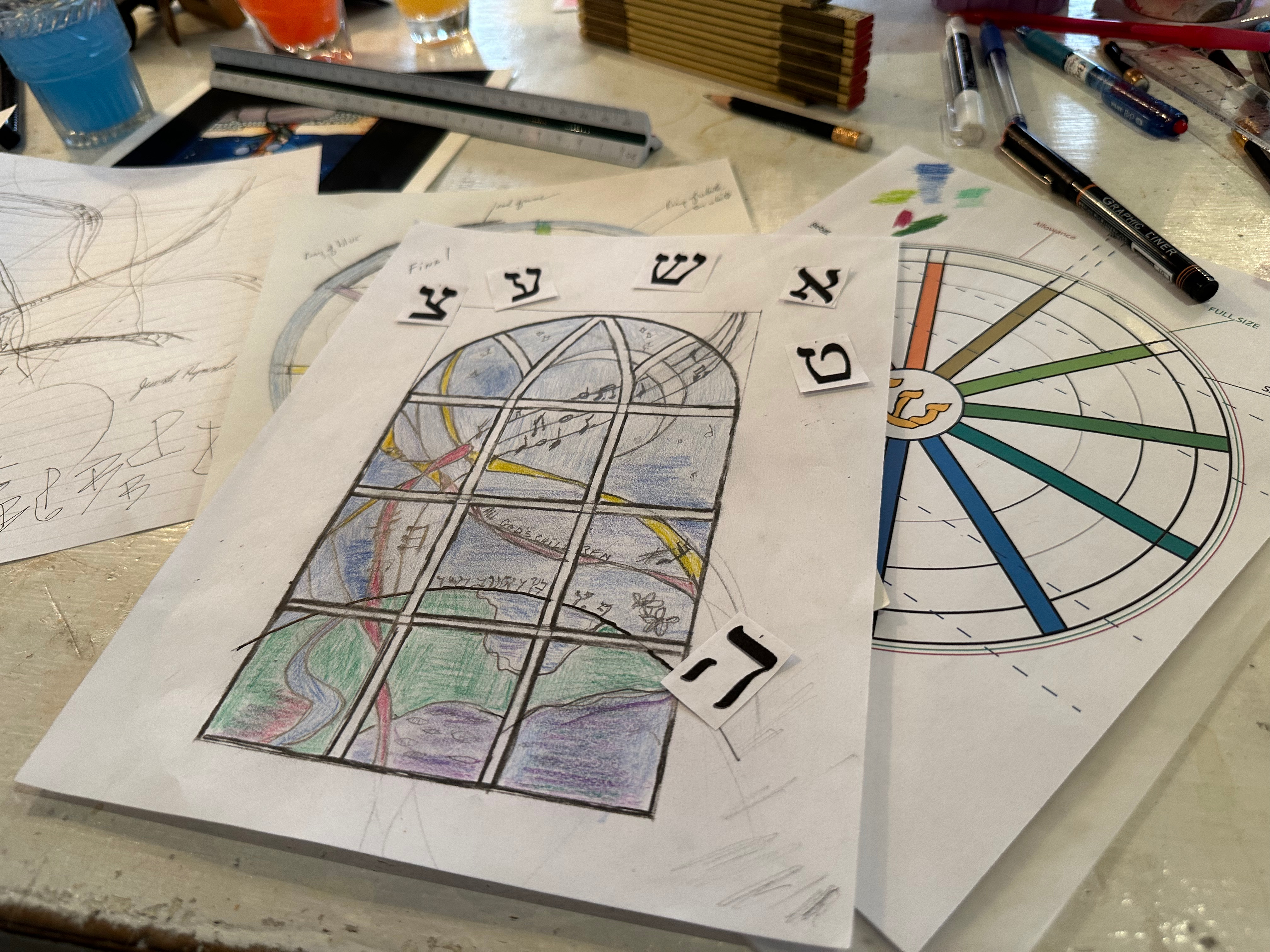 Romany Kramoris at work on a new stained glass window design for Temple Adas Israel. ANNETTE HINKLE