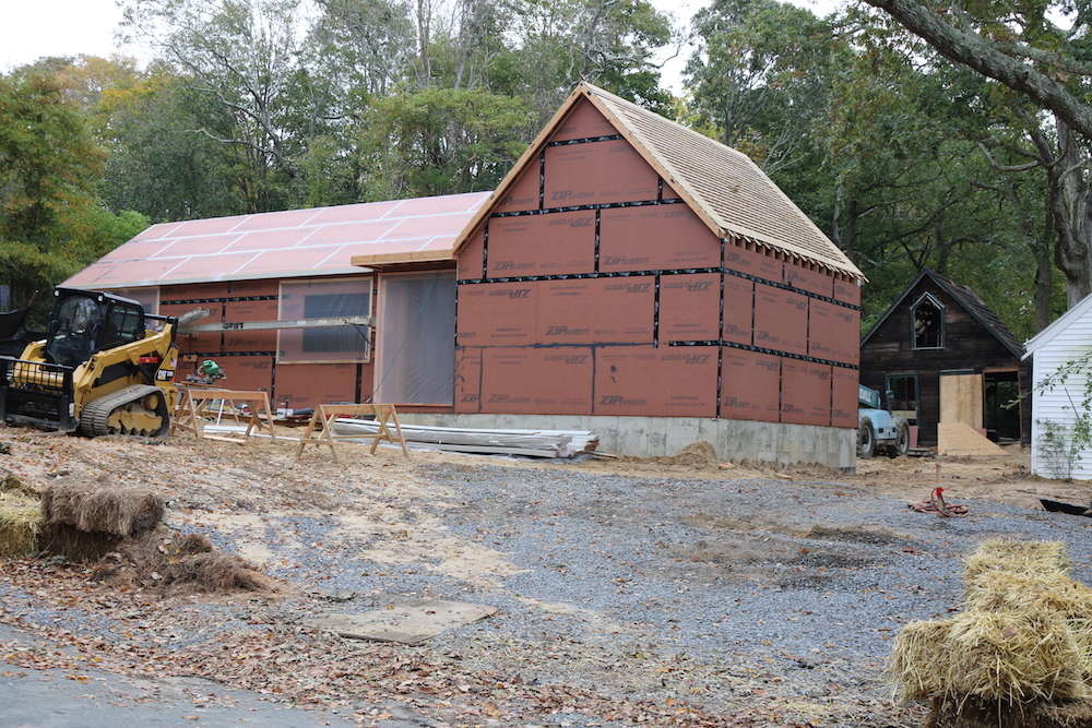 The new house at 20 Grand Street. The old building at right rear was to have been incorporated in the front-gabled section of the new house.   Peter Boody photo