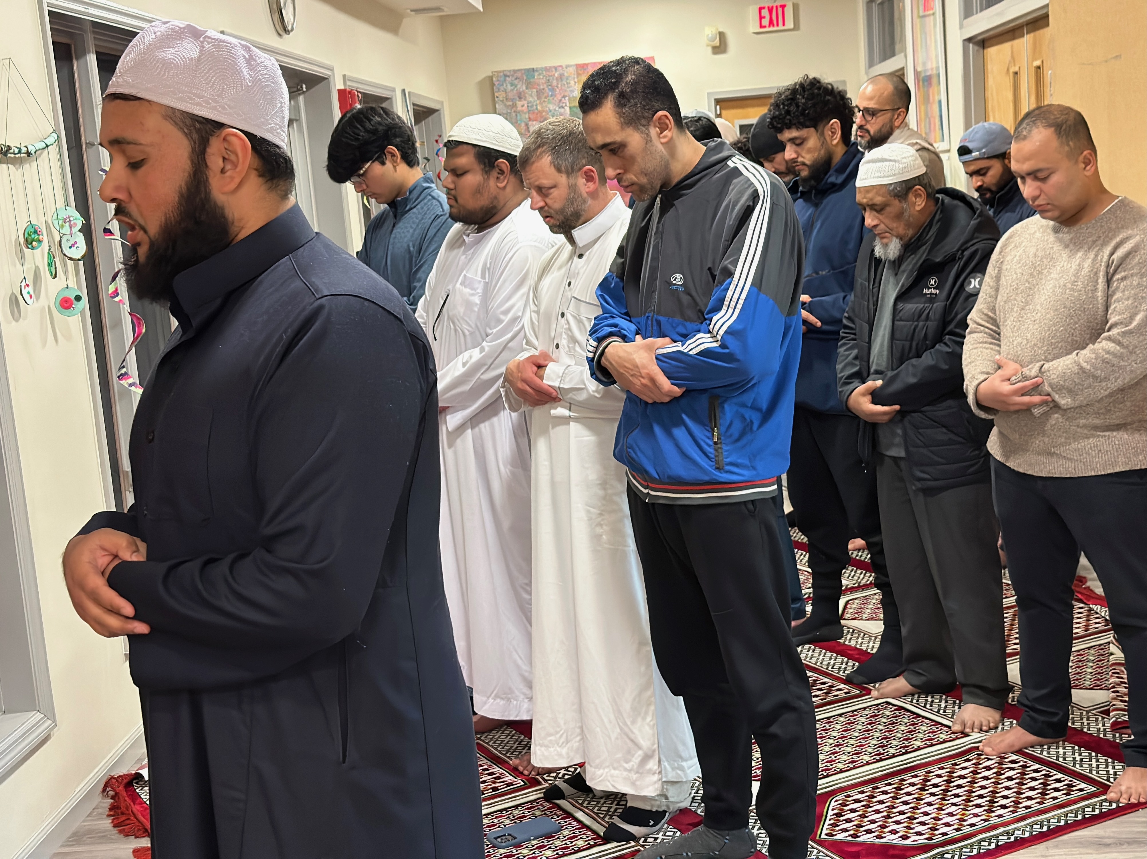 Men praying, led by Imam Mehded of Shirley. Talisman Brolin photo