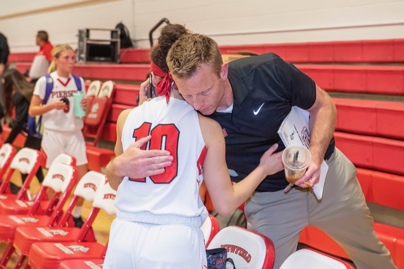 Pierson High School Athletic Director Eric Bramoff hugs Chastin Giles as her career came to an end earlier this month. Michael Heller photo