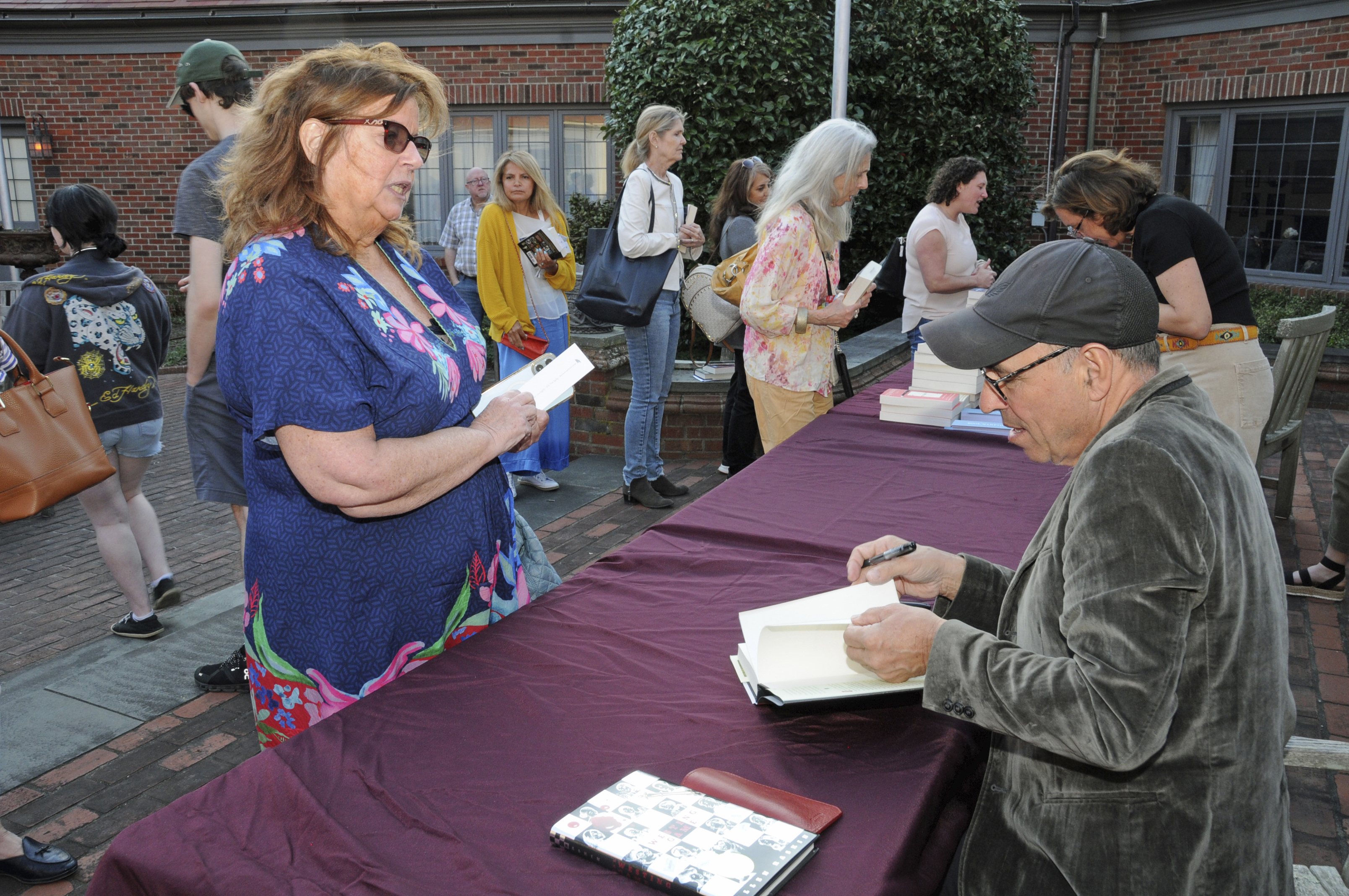 Author Anthony Horowitz signs a book for a fan.