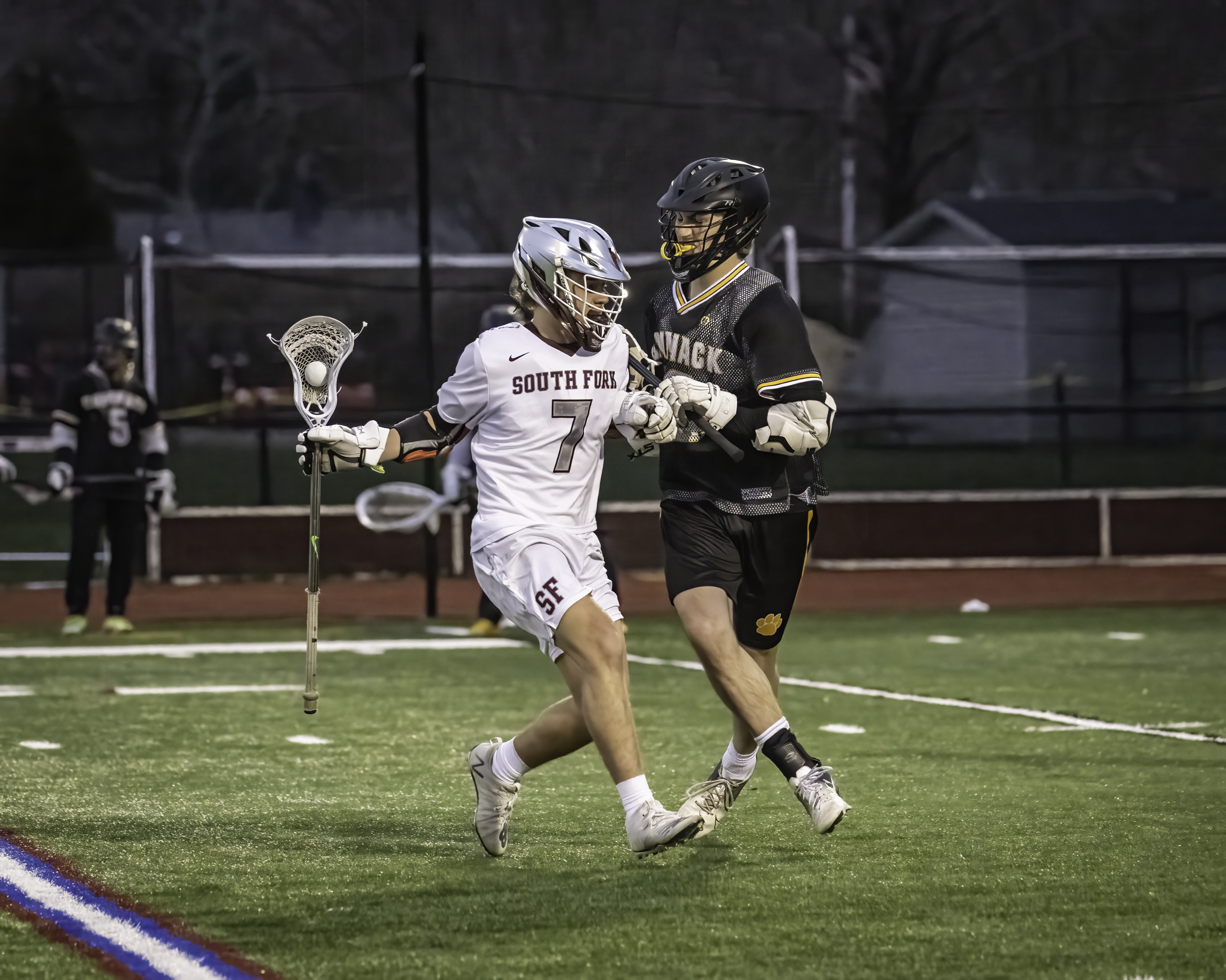 South Fork senior Joe Scully fends off a Commack player.  MARIANNE BARNETT