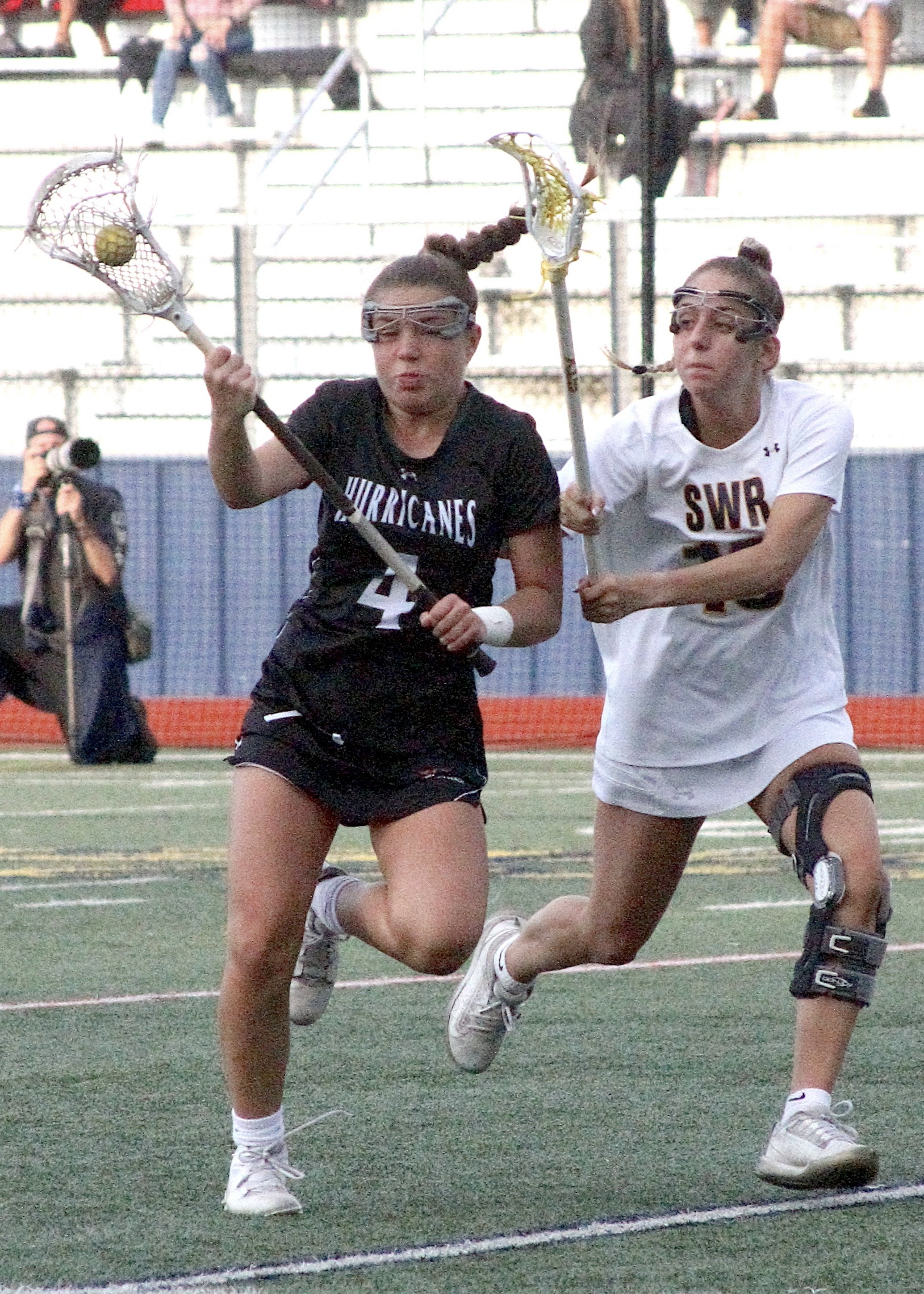 Sophomore attack Brie Provenzano carries the ball up the field with a defender on her hip. DESIRÉE KEEGAN