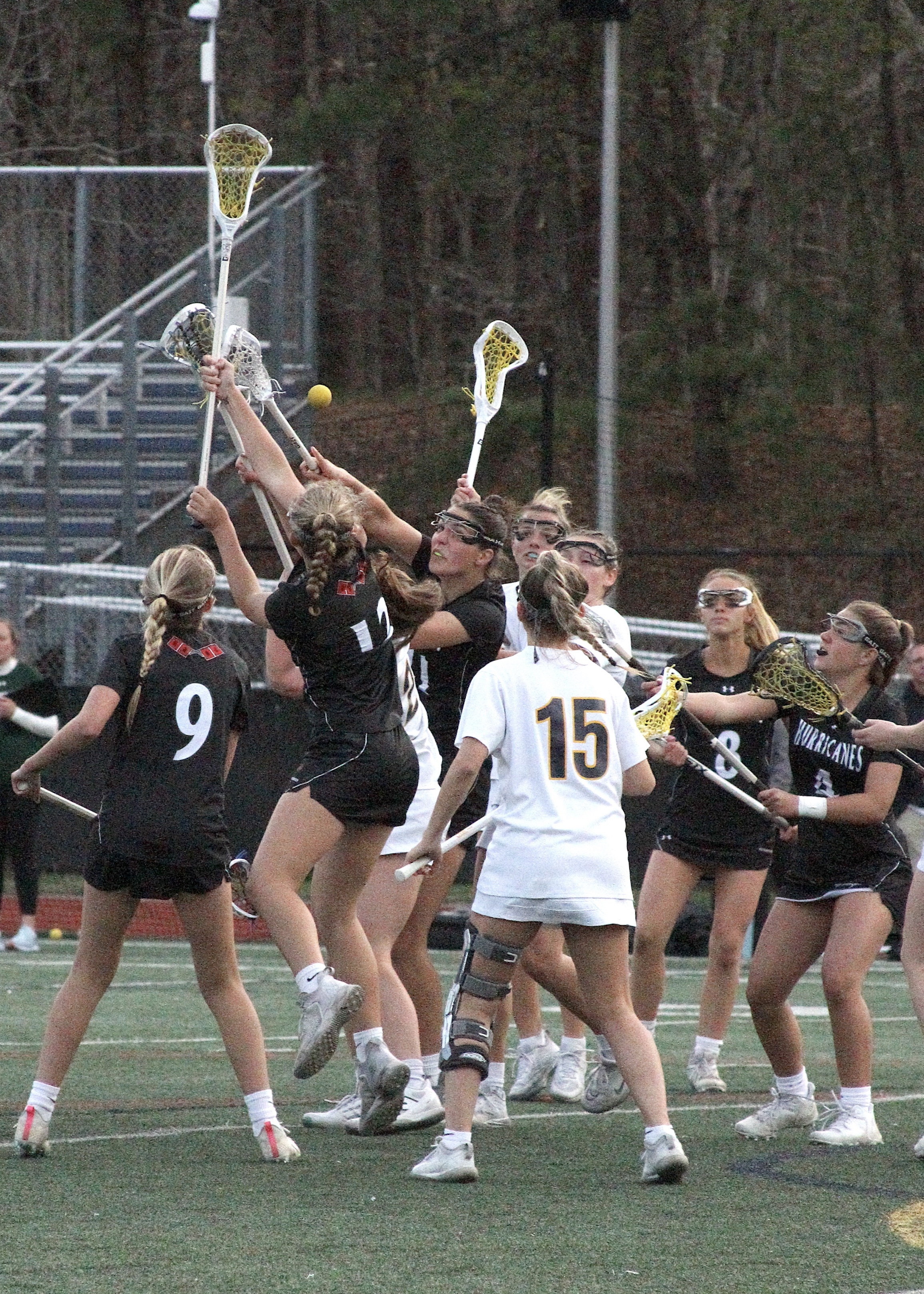 Members of Westhampton Beach's girls lacrosse team fight off Shoreham-Wading River opponents for the loose ball. DESIRÉE KEEGAN