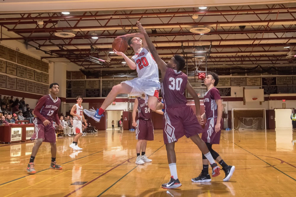 Pierson's Will Martin is blocked at the hoop by East Hampton's Vladimir Rodriguez Garces in the final game of the Kendall Madison Classic at East Hampton High School on Saturday night. Michael Heller photos